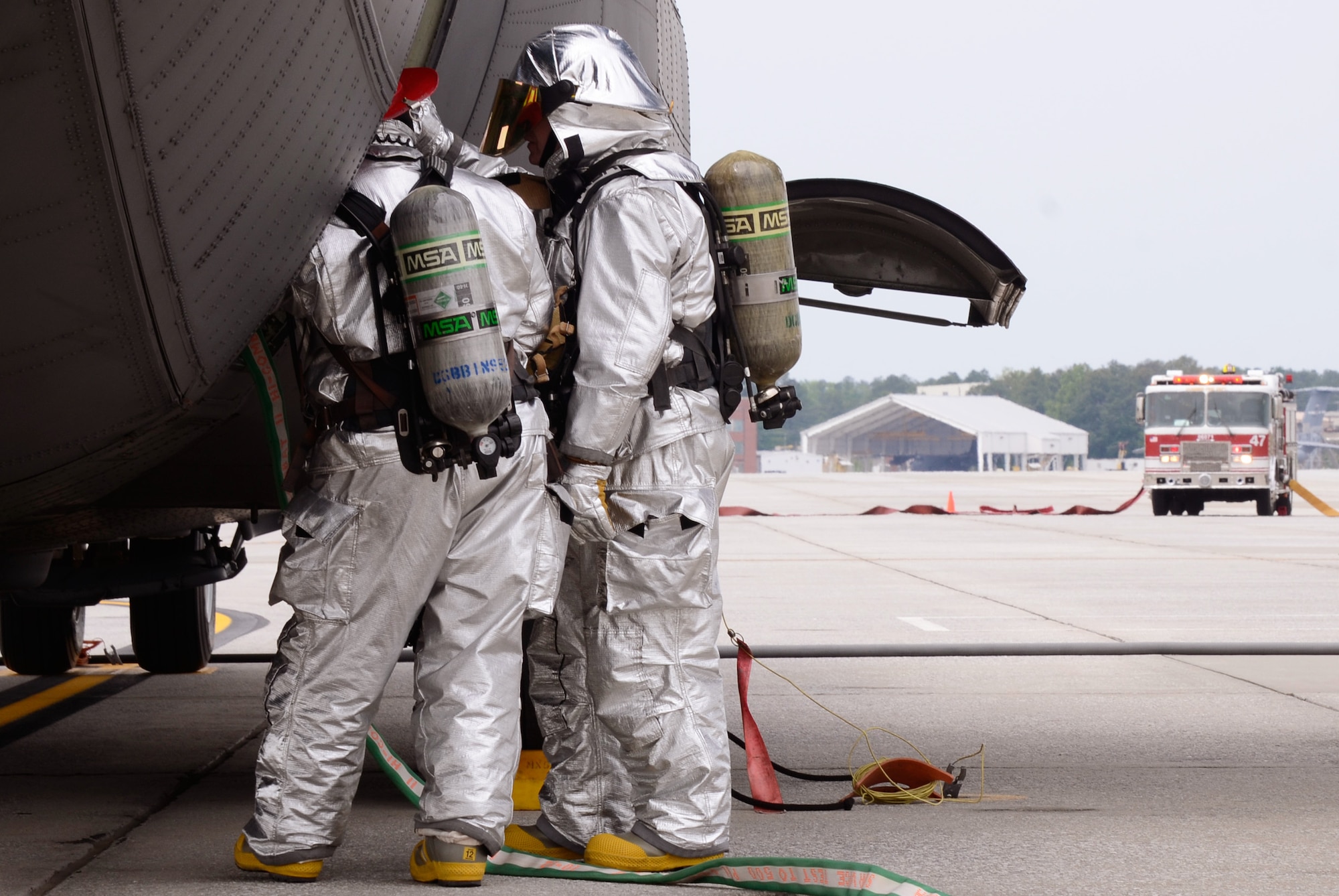 Members of the Dobbins Fire Department search for simulated injured crew members while responding to a realistic scenario involving the collision of an aircraft refueling truck and a C-130 Hercules during an exercise held on Dobbins Air Reserve Base, Ga. May 10. (U.S. Air Force photo/Don Peek)