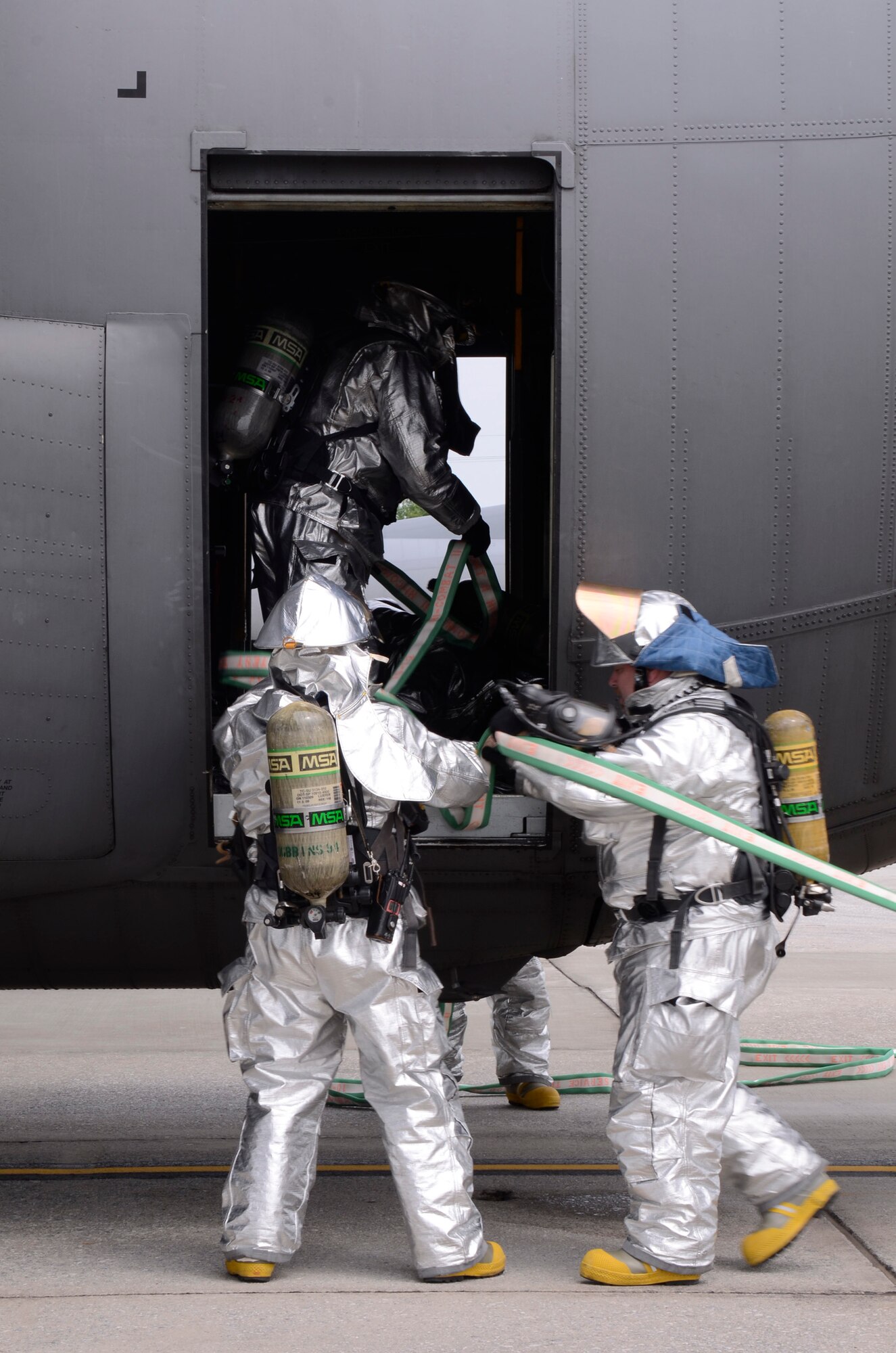 Members of the Dobbins Fire Department search for simulated injured crew members while responding to a realistic scenario involving the collision of an aircraft refueling truck and a C-130 Hercules during an exercise held on Dobbins Air Reserve Base, Ga. May 10. (U.S. Air Force photo/Don Peek)