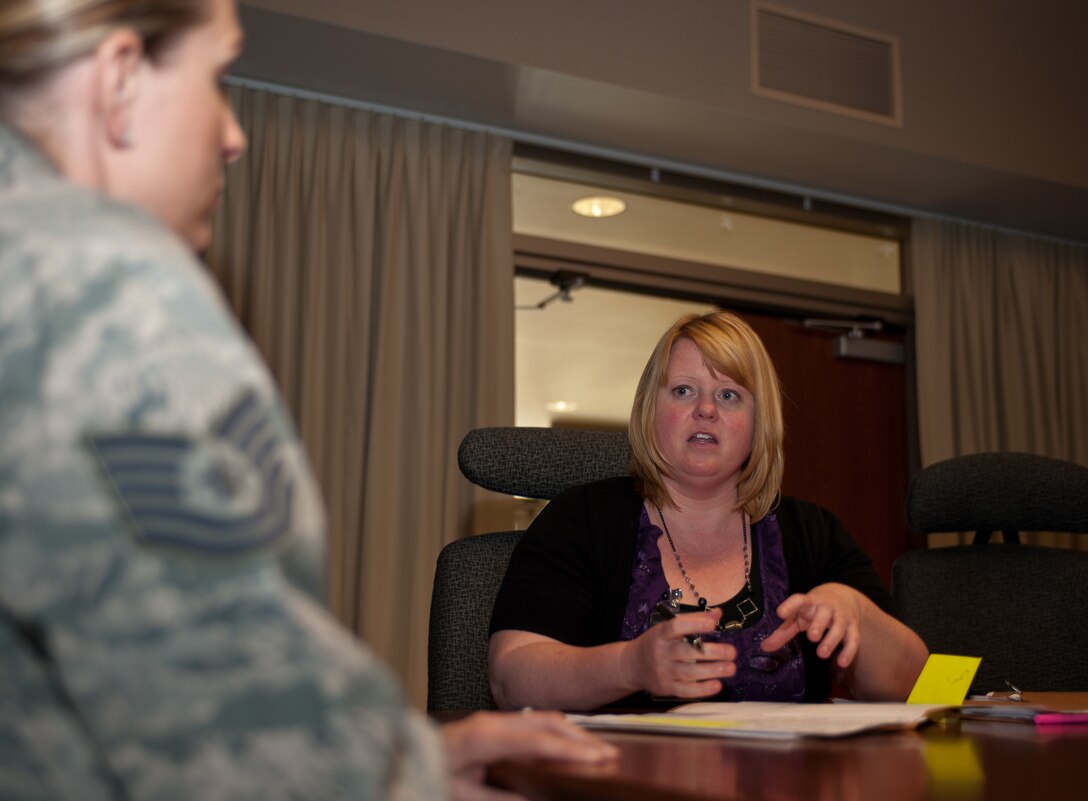 Cheryl Holt, 28th Force Support Squadron education services specialist, answers the questions of Tech. Sgt. Jacqueline Chant, 28th Communications Squadron client systems section chief during a visit from the 28th FSS Education Office at Ellsworth Air Force Base, S.D., May 7, 2013. The meeting was part of the education office’s initiative to visit several work centers to increase their availability to Airmen in need of educational guidance. (U.S. Air Force photo by Airman 1st Class Alystria Maurer/Released)