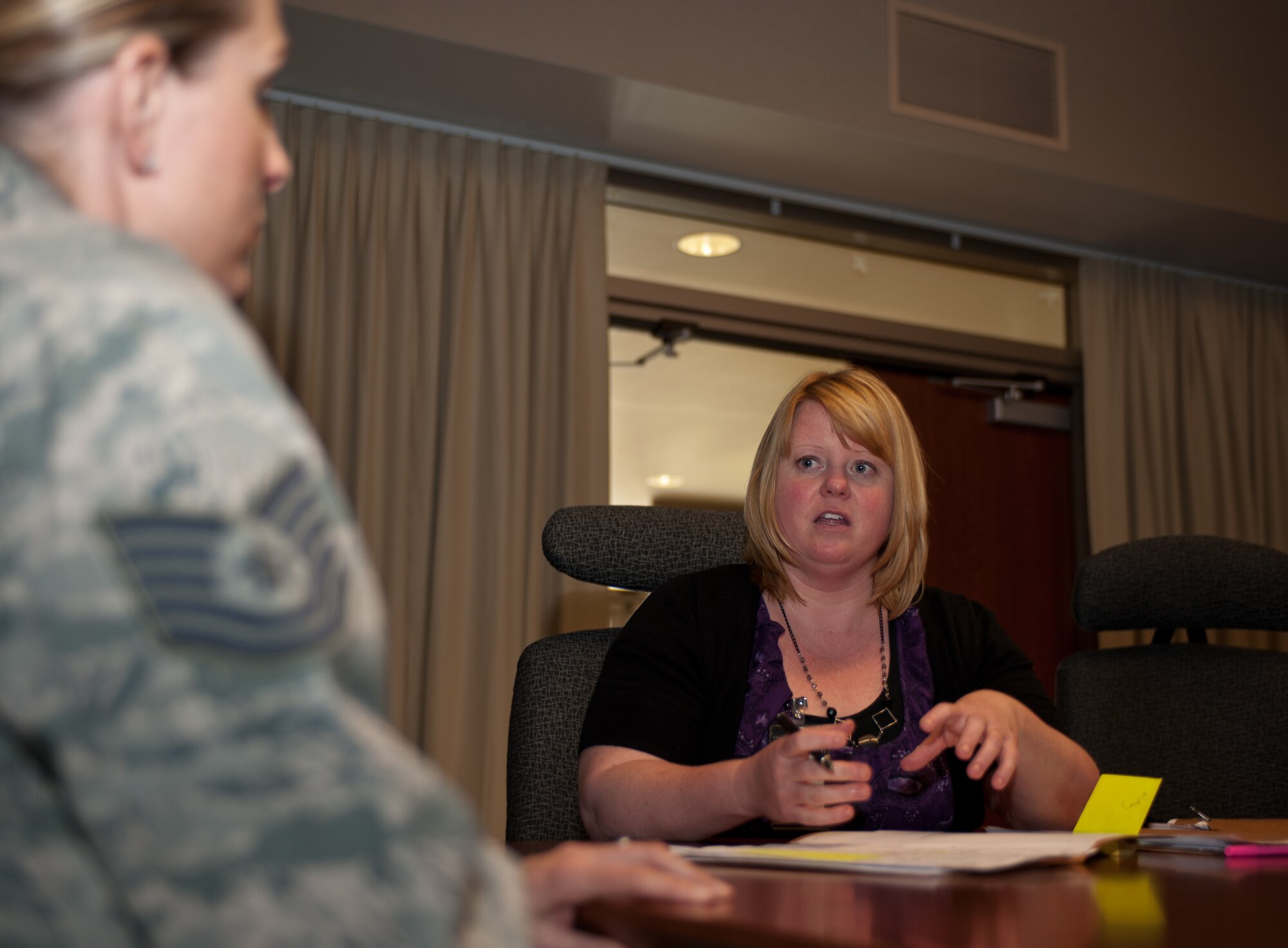 Cheryl Holt, 28th Force Support Squadron education services specialist, answers the questions of Tech. Sgt. Jacqueline Chant, 28th Communications Squadron client systems section chief during a visit from the 28th FSS Education Office at Ellsworth Air Force Base, S.D., May 7, 2013. The meeting was part of the education office’s initiative to visit several work centers to increase their availability to Airmen in need of educational guidance. (U.S. Air Force photo by Airman 1st Class Alystria Maurer/Released)