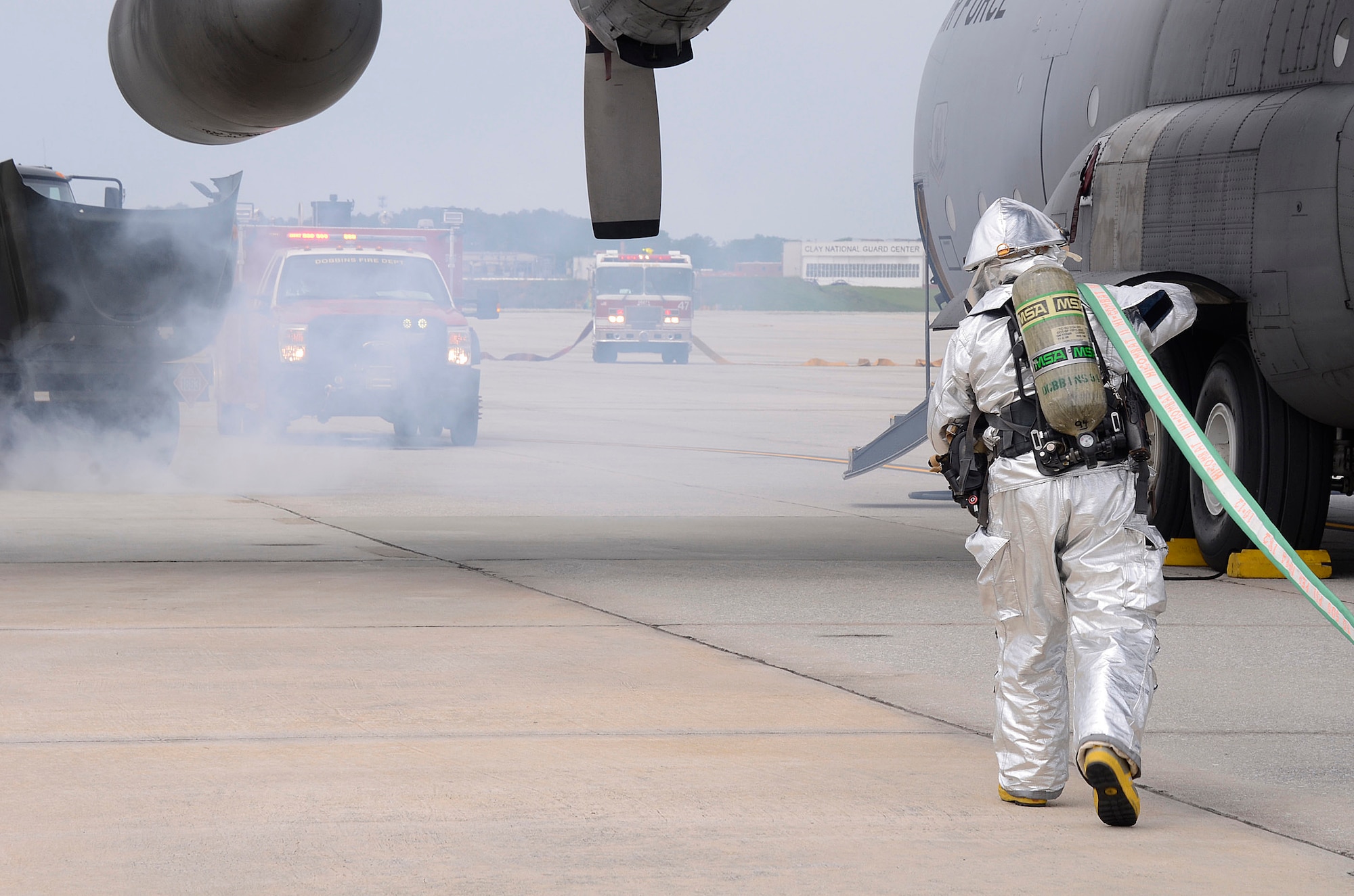 Members of the Dobbins Fire Department respond to a simulated incident involving a collision of an aircraft refueling truck and a C-130 Hercules during a major accident response exercise (MARE) held on Dobbins Air Reserve Base, Ga. May 10. (U.S. Air Force photo/Don Peek)