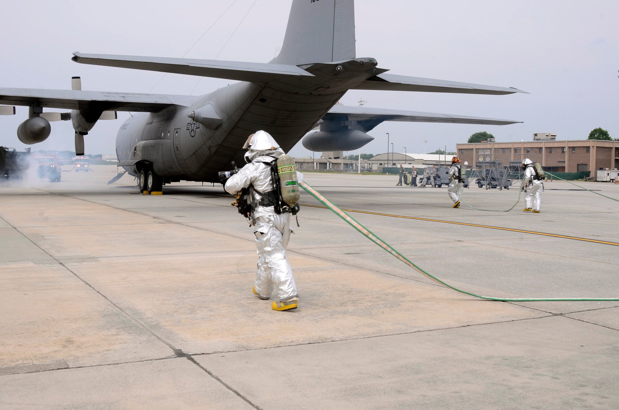 Members of the Dobbins Fire Department respond to a simulated incident involving a collision of an aircraft refueling truck and a C-130 Hercules during a major accident response exercise (MARE) held on Dobbins Air Reserve Base, Ga. May 10. (U.S. Air Force photo/Don Peek)