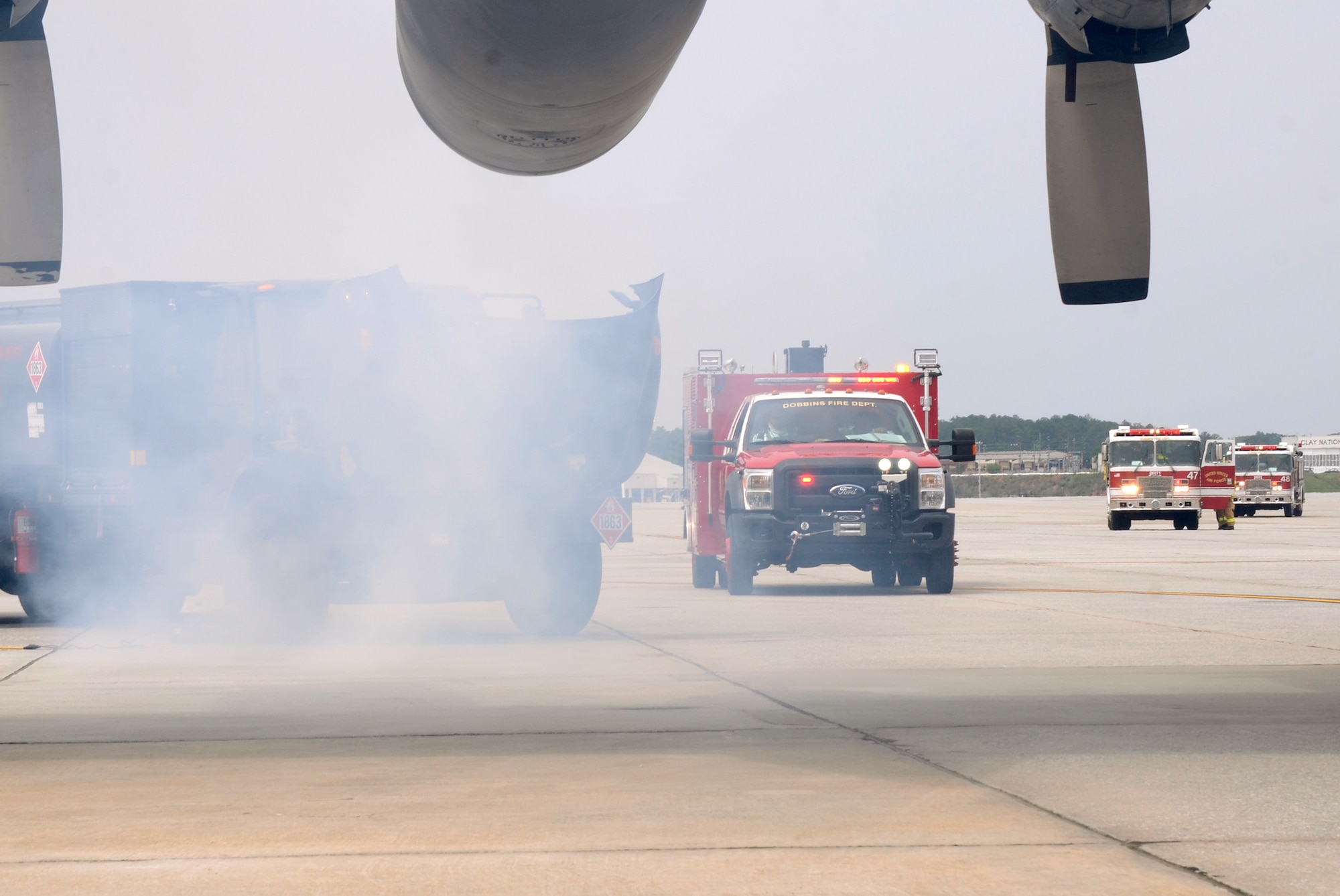 Members of the Dobbins Fire Department respond to a simulated incident involving a collision of an aircraft refueling truck and a C-130 Hercules during a major accident response exercise (MARE) held on Dobbins Air Reserve Base, Ga. May 10. (U.S. Air Force photo/Don Peek)