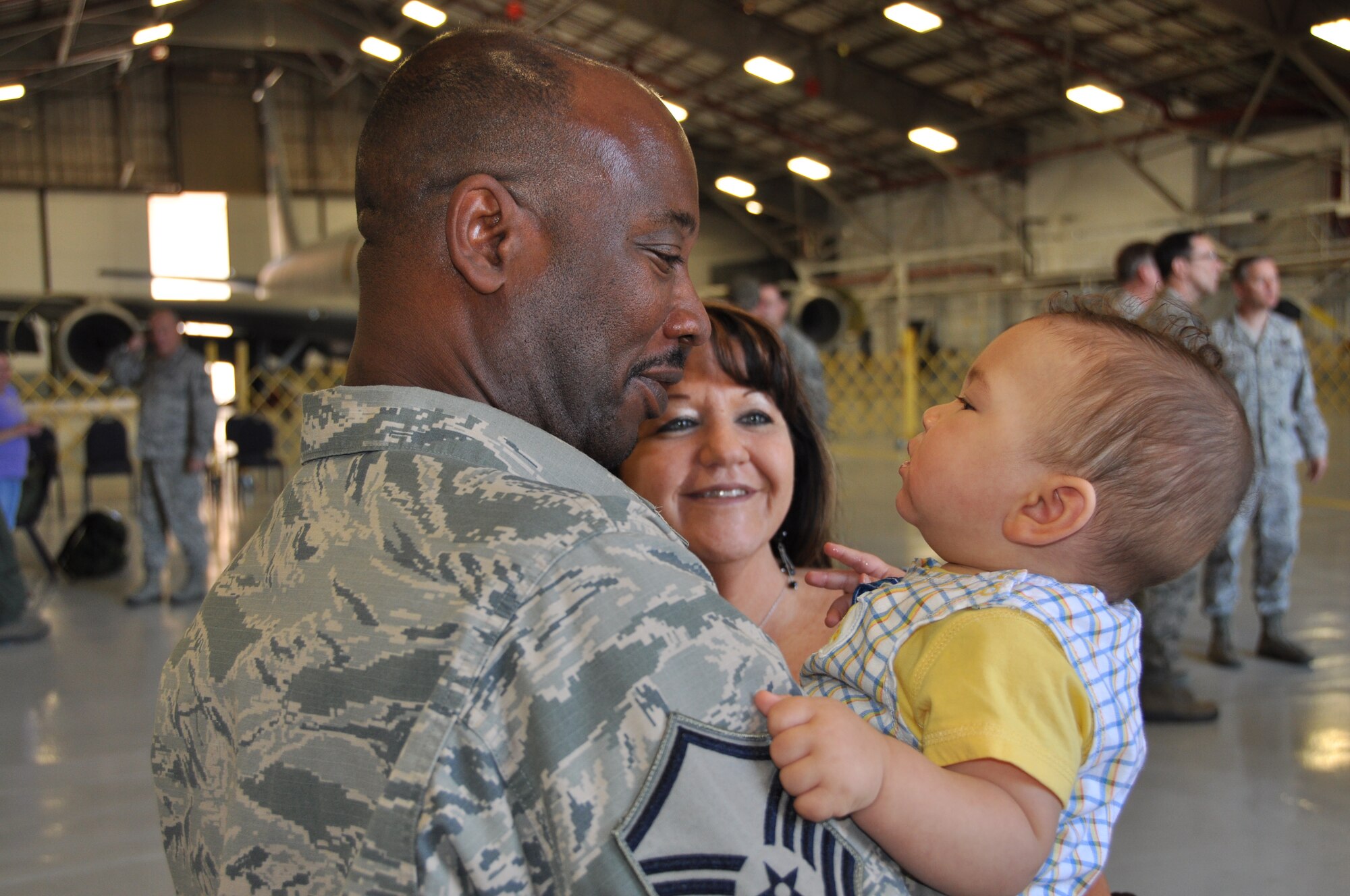 Master Sgt. Fernandzo Holmes, 507th Aircraft Maintance Squadron greets his family after returning from a five month deployment in South West Asia here May 13. (U.S. Air Force photo by Maj. Jon Quinlan) 
