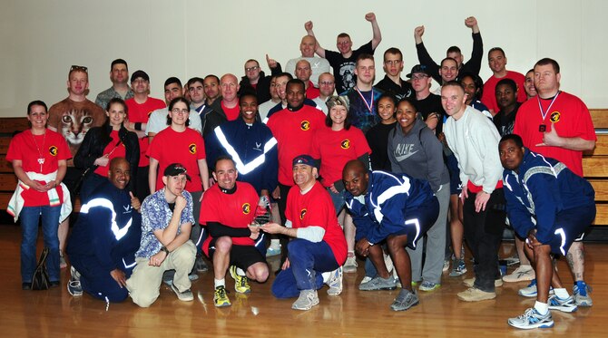 Airmen from the 100th Communications Squadron show off their trophy after a post Unit Effectiveness Inspection sports challenge May 10, 2013, at RAF Mildenhall, England. The 100th CS won overall, collecting points over several events including kick ball, tug of war and arm wrestling. (U.S. Air Force photo by Karen Abeyasekere/Released)