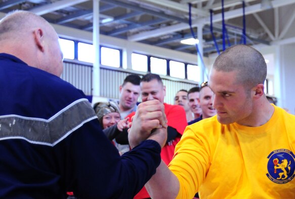 From left, Chief Master Sgt. David Lee, 100th Maintenance Group superintendent, takes on Airman 1st Class Thomas Devereaux, 100th Operations Support Group Aircrew Flight Equipment apprentice, in an arm-wrestling contest May 10, 2013, at RAF Mildenhall, England. Team Mildenhall members started the day with a formation fun, followed by a barbecue and sports challenges including tug of war, kick ball and “slip-n-slide.” (U.S. Air Force photo by Airman 1st Class Dillon Johnston)