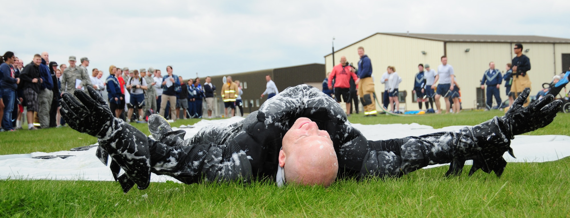 “Batman” (Master Sgt. Thomas Wagner, 100th Maintenance Squadron first sergeant) admits defeat after doing the “slip-n-slide” May 10, 2013, at a post Unit Effectiveness Inspection on RAF Mildenhall, England. Batman also took part in the hurdles, arm wrestling and tug of war events, competing against Col. Christopher Kulas, 100th Air Refueling Wing commander, and other Team Mildenhall Airmen. (U.S. Air Force photo by Karen Abeyasekere/Released)