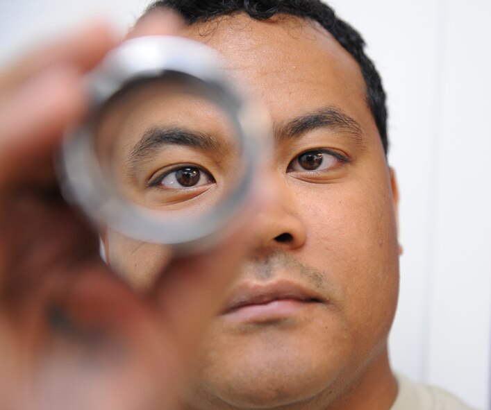 Staff Sgt. Mervie Dotson, 2nd Civil Engineer Squadron Utilities shop, inspects a coupling for serviceability on Barksdale Air Force Base, La., May 13, 2013. The 2nd CES Utilities shop specializes in the piping and water treatment systems on the base. (U.S. Air Force photo/Airman 1st Class Benjamin Gonsier)
