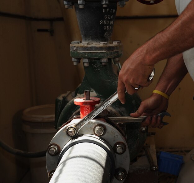 Michael Scott, 2nd Civil Engineer Squadron plumber, tightens a bolt on a water pipe on Barksdale Air Force Base, La., May 13, 2013. The 2nd CES Utilities shop specializes in the piping and water treatment systems on the base. (U.S. Air Force photo/Airman 1st Class Benjamin Gonsier)
