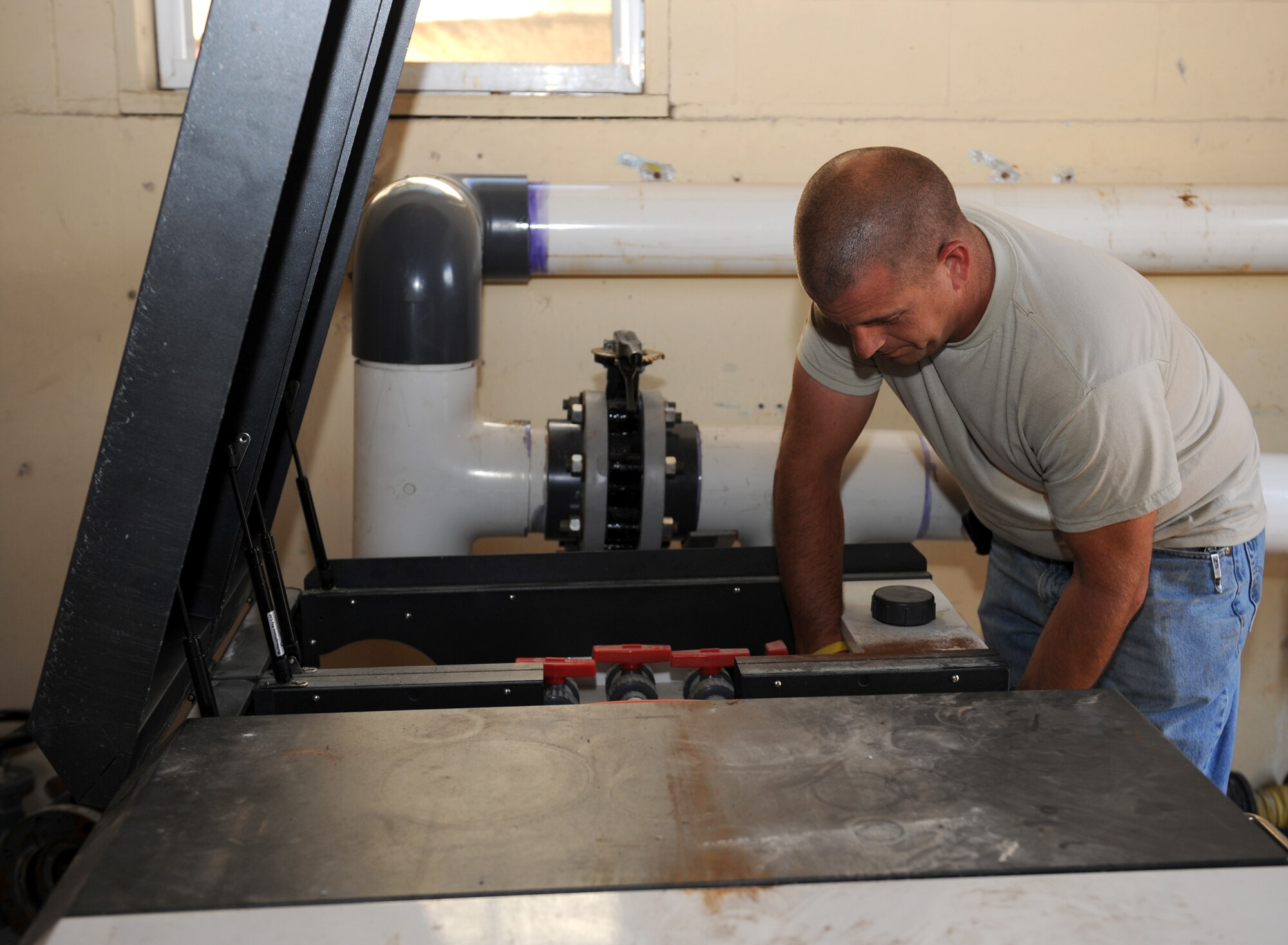 Michael Scott, 2nd Civil Engineer Squadron plumber, installs a part into a salt water chlorination machine on Barksdale Air Force Base, La., May 13, 2013. The salt water chlorination machine converts salt inside the pool to chlorine in order to disinfect it. (U.S. Air Force photo/Airman 1st Class Benjamin Gonsier)
