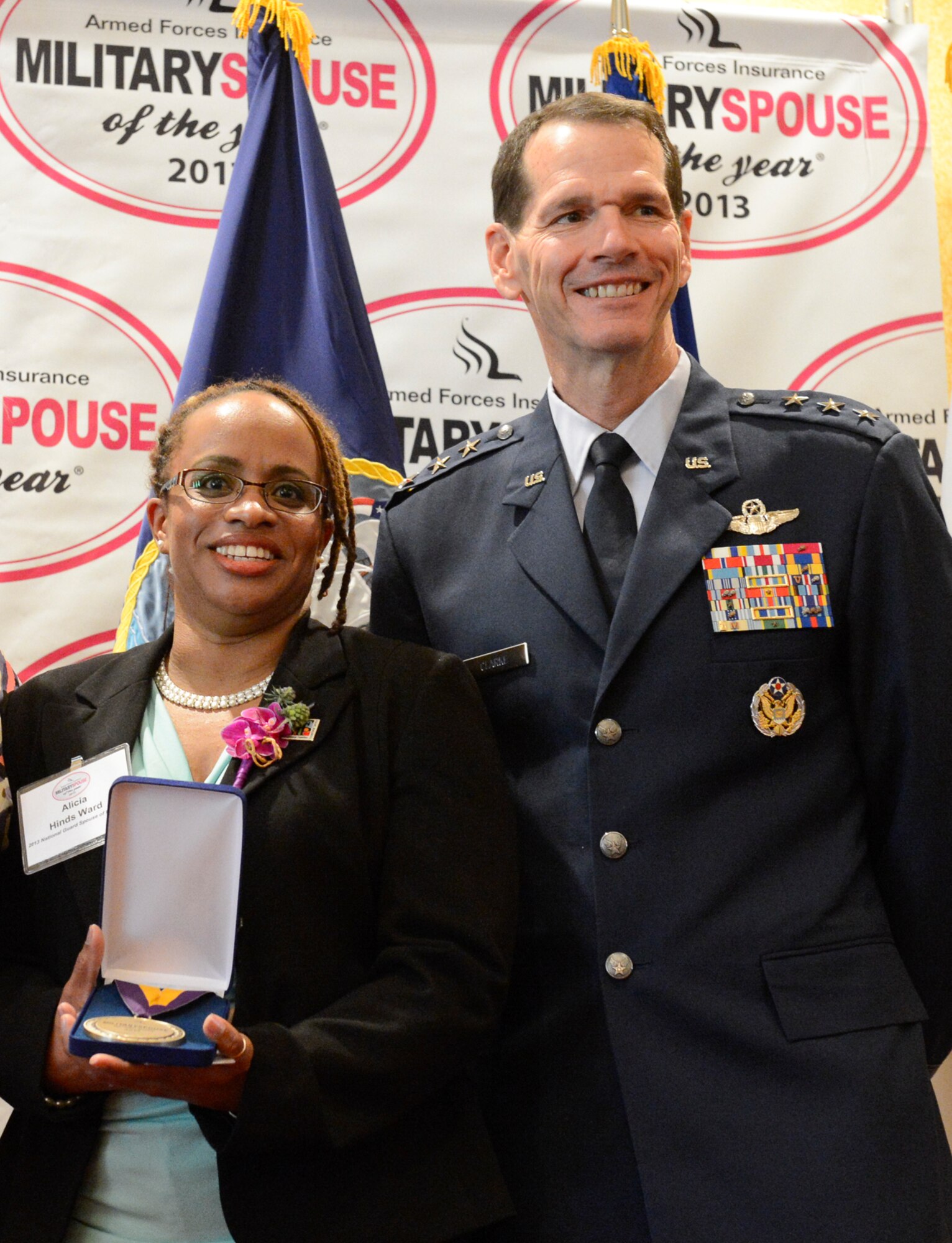 Alicia Hinds Ward, 2013 National Guard Spouse of the Year, poses for a photo with Lt. Gen. Stanley E. Clarke III, the director of the Air National Guard after winning the 2013 Military Spouse of the Year award, in Arlington, Va., May 9, 2013. The awards, presented by Military Spouse magazine and sponsored by Armed Forces Insurance, honor spouses of military members. (Air Force photo by Scott Ash)