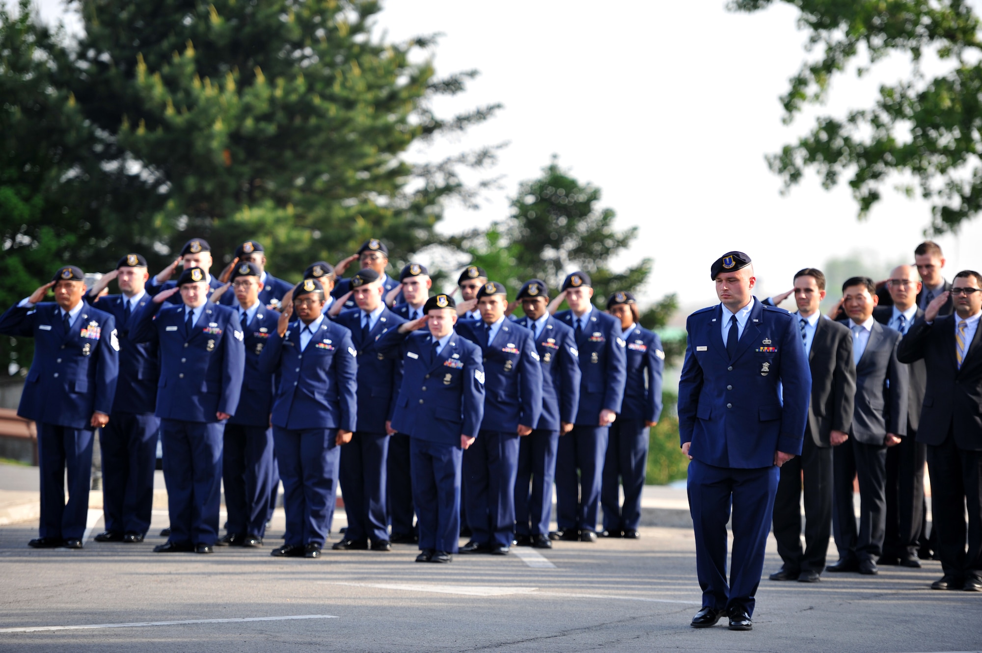 Airmen from the 51st Security Forces Squadron and Office of Special Investigations salute during a retreat ceremony at Osan Air Base, Republic of Korea, May 13, 2013. The ceremony kicked off an annual week-long observance that’s held to honor the memory and sacrifices made by individuals in the security forces and Office of Special Investigations career fields. (U.S. Air Force photo/Staff Sgt. Emerson Nuñez)