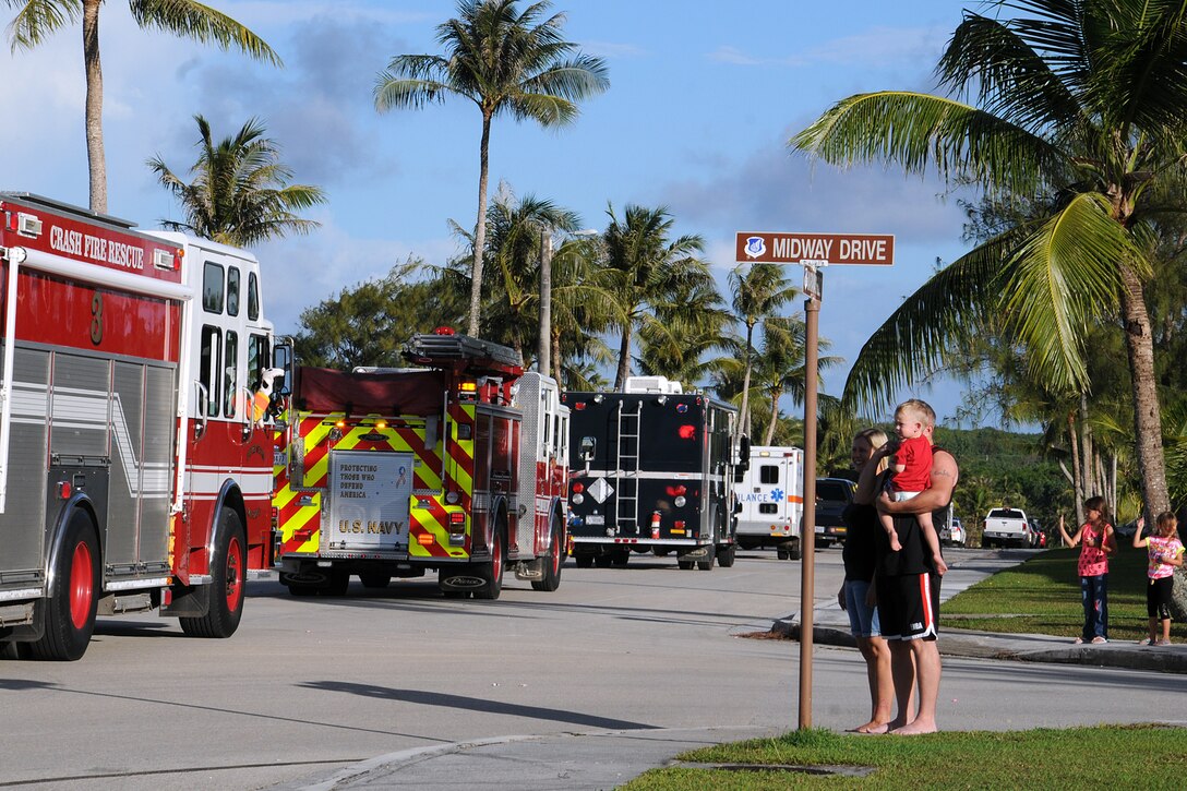 Families watch more than 30 Airmen in 12 emergency services vehicles drive by during the National Police Week parade on Andersen Air Force Base, Guam, May 14, 2013. In 1962, President John F. Kennedy designated May 15 as Peace Officers Memorial Day and the week in which that date falls as National Police Week to recognize law enforcement professionals and their sacrifices.
(U.S. Air Force photo by Staff Sgt. Melissa B. White/Released)