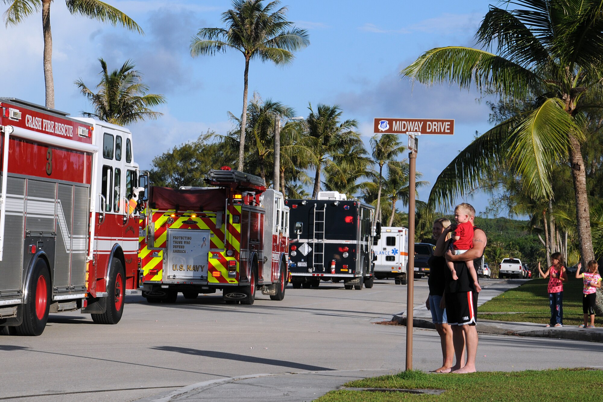 Families watch more than 30 Airmen in 12 emergency services vehicles drive by during the National Police Week parade on Andersen Air Force Base, Guam, May 14, 2013. In 1962, President John F. Kennedy designated May 15 as Peace Officers Memorial Day and the week in which that date falls as National Police Week to recognize law enforcement professionals and their sacrifices.
(U.S. Air Force photo by Staff Sgt. Melissa B. White/Released)