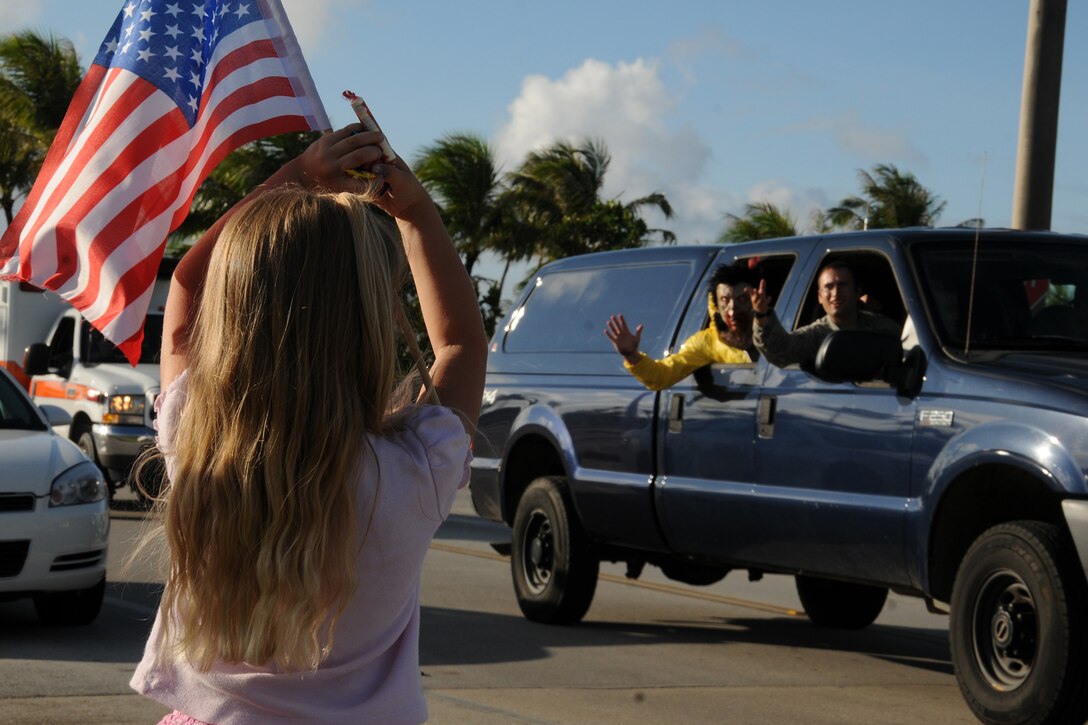 A military child catches candy during the National Police Week parade on Andersen Air Force Base, Guam, May 14, 2013. In 1962, President John F. Kennedy designated May 15 as Peace Officers Memorial Day and the week in which that date falls as National Police Week to recognize law enforcement professionals and their sacrifices. (U.S. Air Force photo by Staff Sgt. Melissa B. White/Released)