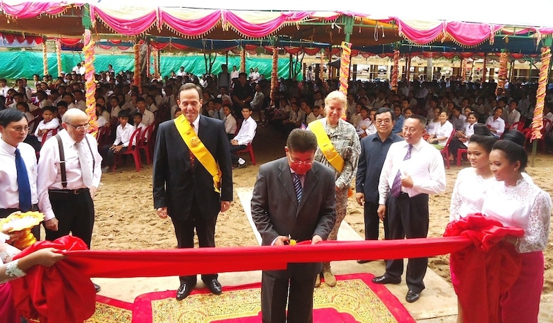 His Excellency Im Sethy, Cambodian Minister of Education, Youth and Sports, cuts a ribbon to celebrate the completion of Preah Ang Duong High School on April 23 in Prey Veng City, Cambodia.  Behind him from left are the Honorable William E. Todd, U.S. Ambassador to Cambodia, and Lt. Col. Kristin A. Means, Chief of the Office of Defense Cooperation for the U.S. Embassy in Cambodia.