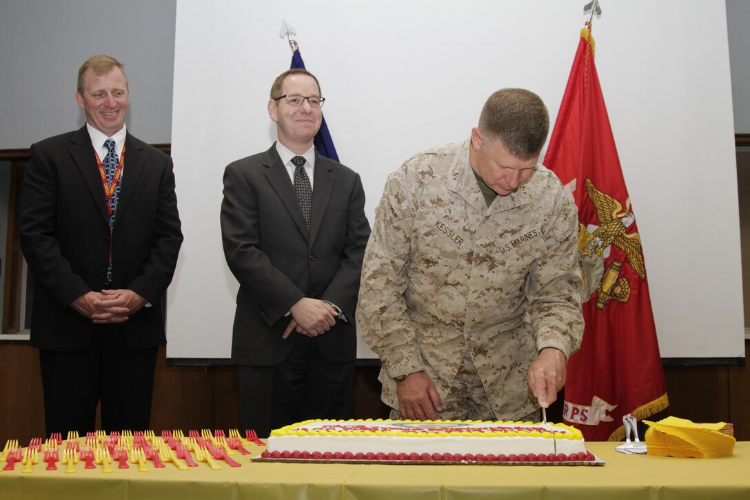 Maj. Gen. James A. Kessler, commanding general of Marine Corps Installations Command and the assistant deputy commandant of Installations and Logistics, cuts a piece of cake during a cake cutting ceremony at Kansas City Installations Technology Center (KCITC)in Kansas City Mo on May 14, 2013. Kessler’s toured the facilities of KCITC for the initial operational capable celebration of the branch.