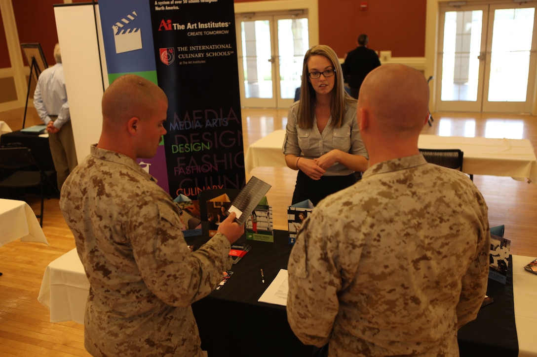 Lance Cpl. Joseph Robbins and Lance Cpl. Aaron Hardy, 8th Communications General Support Battalion Marines, review the available programs available to them during the Marine Corps at the National Education and Job Fair at the Marston Pavilion aboard Marine Corps Base Camp Lejeune April 18. The expo and fair are biannual events. (Photo by Pfc. Justin A. Rodriguez/released)