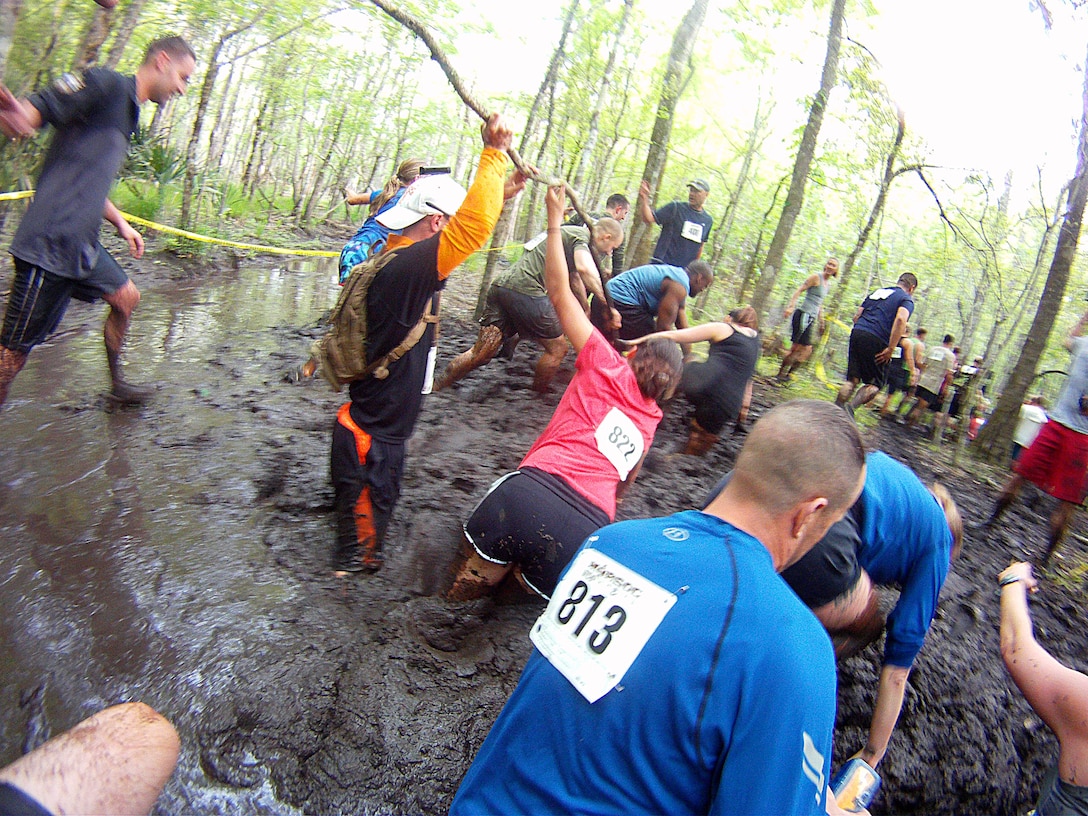 Participants of the infamous “Mud, Seat and Tears Run” sponsored by U.S. Marine Corps Forces, Special Operations Command, endure an intense trail filled with forest terrain, winding trails, fallen trees and giant mud pits April 27, 2013. The run consisted of a five-mile trek through the woods and muddy terrain of Stone Bay. 