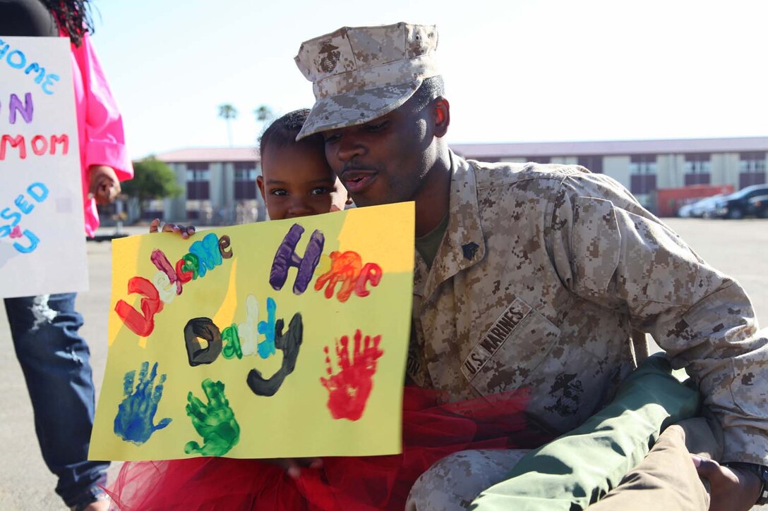 Sergeant Kristopher Robinson, maintenance management chief, Command Element, 15th Marine Expeditionary Unit, embraces his daughter after returning to Camp Pendleton, Calif., from an eight-month deployment aboard USS Peleliu, May 13. The 15th MEU, comprised of approximately 2,400 Marines and sailors, deployed on Sept. 17, 2012, as part of the Peleliu Amphibious Ready Group. Together with Amphibious Squadron Three, they provided a forward-deployed, flexible sea-based Marine Air Ground Task Force capable of conducting a wide variety of operations ranging from humanitarian aid to combat. (U.S. Marine Corps photo by Cpl. Timothy Childers / Released)