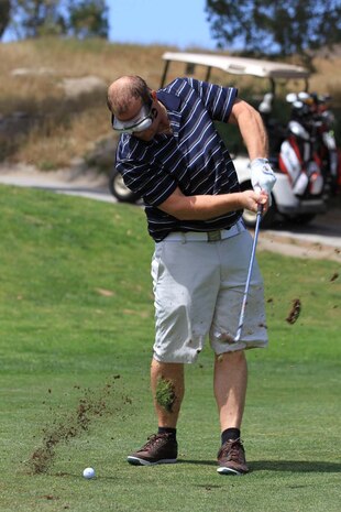 Gregg Engels, the owner of Cigar Grotto in Oceanside, tees off with alcohol impairment goggles at the Commanding General's 2nd Invitational Golf Tournament at the Marine Memorial Golf Course here, May 14, 2013. The tournament provided a unique opportunity for Marines and sailors to network and share experiences with business and community leaders as well as golf industry experts. Each of the 18 holes on the course gave the participants challenges, varying from wearing a flak jacket to playing with alcohol impairment goggles. The intent of the invitational was to highlight facilities aboard the base that are accessible to civilians and provide information about the installation to invited guests.