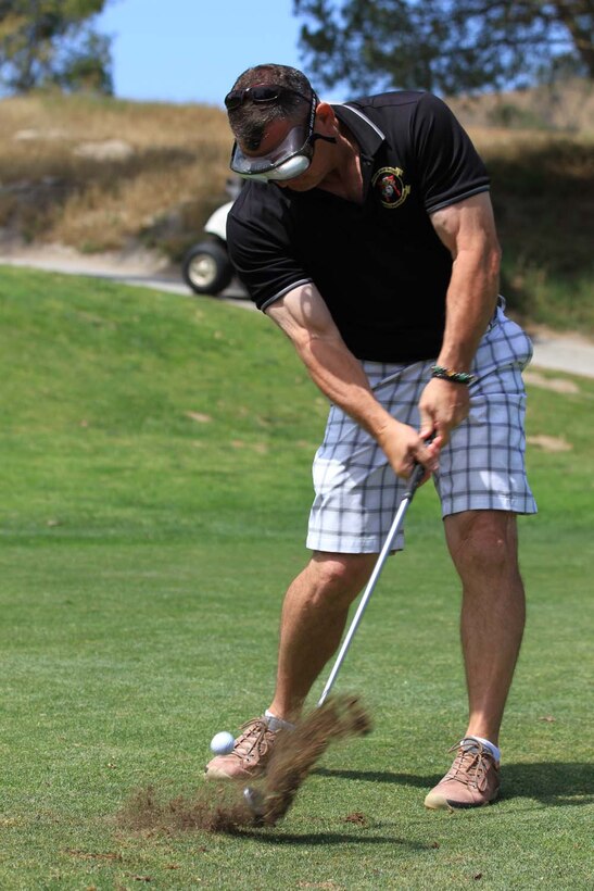 Colonel Sean Sadler, the former commanding officer of Marine Aircraft Group 39, tees off with alcohol impairment goggles at the Commanding General's 2nd Invitational Golf Tournament at the Marine Memorial Golf Course here, May 14, 2013. The tournament provided a unique opportunity for Marines and sailors to network and share experiences with business and community leaders as well as golf industry experts. Each of the 18 holes on the course gave the participants challenges, varying from wearing a flak jacket to playing with alcohol impairment goggles. The intent of the invitational was to highlight facilities aboard the base that are accessible to civilians and provide information about the installation to invited guests.