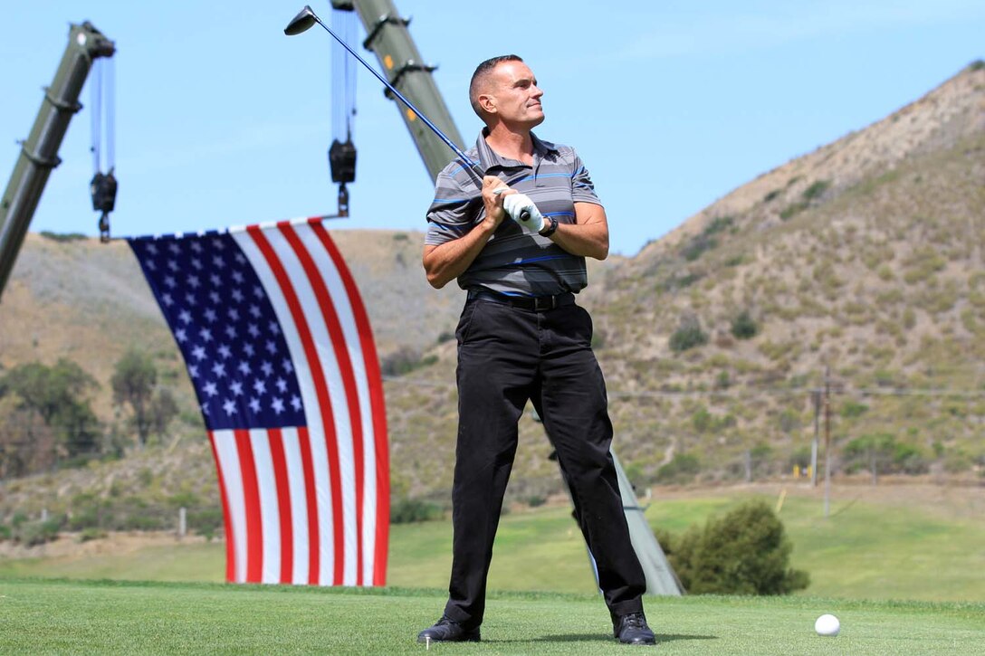 Brigadier Gen. Vincent Coglianese, the commanding general for Marine Corps Base Camp Pendleton and regional authority for five Marine Corps Installations in southwestern United States, watches his golf ball after teeing off at the first hole during the Commanding General's 2nd Invitational Golf Tournament at the Marine Memorial Golf Course here, May 14, 2013. The tournament provided a unique opportunity for Marines and sailors to network and share experiences with business and community leaders as well as golf industry experts. Each of the 18 holes on the course gave the participants challenges, varying from wearing a flak jacket to playing with alcohol impairment goggles. The intent of the invitational was to highlight facilities aboard the base that are accessible to civilians and provide information about the installation to invited guests.