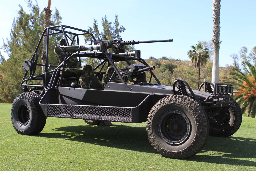 A Desert Patrol Vehicle is staged at one of the holes at the Commanding General's 2nd Invitational Golf Tournament at the Marine Memorial Golf Course here, May 14, 2013. The tournament provided a unique opportunity for Marines and sailors to network and share experiences with business and community leaders as well as golf industry experts. Each of the 18 holes on the course gave the participants challenges, varying from wearing a flak jacket to playing with alcohol impairment goggles. The intent of the invitational was to highlight facilities aboard the base that are accessible to civilians and provide information about the installation to invited guests.