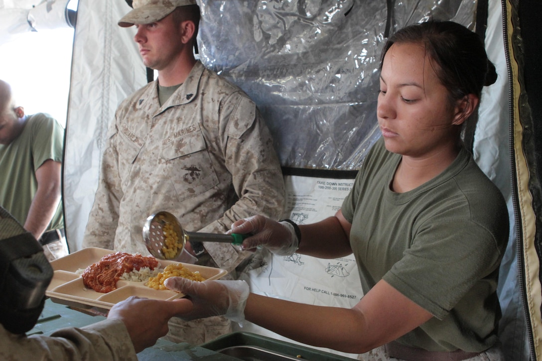 Sergeant Letty Y. Vazquez, a food service specialist serving with Food Service Company, Combat Logistics Regiment 17, 1st Marine 
Logistics Group, serves dinner to Marines with 1st Marine Division during Exercise Desert Scimitar aboard Marine Corps Air Ground 
Combat Center Twentynine Palms, Calif., May 1, 2013. Vazquez, a 25-year-old native of Bayamon, Puerto Rico, was attached to the 
division for nearly two weeks to prepare and serve hot meals for more than 600 Marines and sailors. Her team of food service specialists often worked more than 20 hours each day to feed the division.