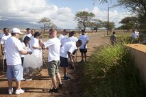 Volunteers and Marines with Combat Logistics Battalion 3 clean up trash at Oneula Beach Park on Ewa Beach to help raise money for the Make-A-Wish Hawaii organization, May 7.