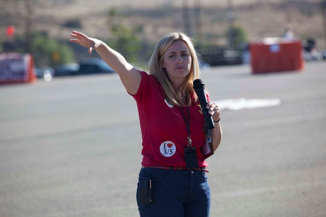 Kimberly Reese, the family readiness officer for 3rd Battalion, 5th Marine Regiment, speaks to  family members as Marines prepare to march onto the San Mateo parade deck here, on May 13, 2013. Families and friends reunited with their Marines and sailors after an eight-month deployment with the 15th Marine Expeditionary Unit. The MEU deployed Sept 17, 2012, and traveled to Dubai, Jordan, Oman, China, and Hawaii.