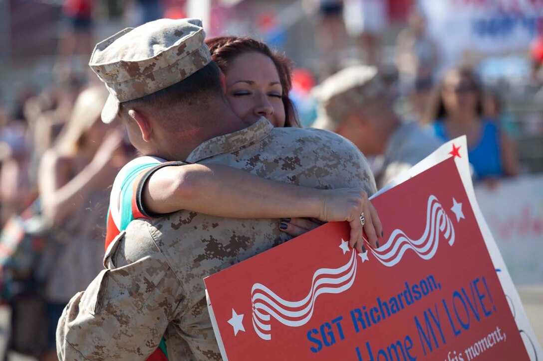 Sergeant Nick Richardson, an Infantryman serving with Weapons Company, 3rd Battalion, 5th Marine Regiment and a native of Broken Arrow, Okla., hugs his wife, Lana, after being dismissed from a formation on the San Mateo parade deck here, May 13, 2013. Families and friends watched their Marines and sailors march onto the parade deck after an eight-month deployment with the 15th Marine Expeditionary Unit. The MEU deployed Sept 17, 2012, and traveled to Dubai, Jordan, Oman, China, and Hawaii.
