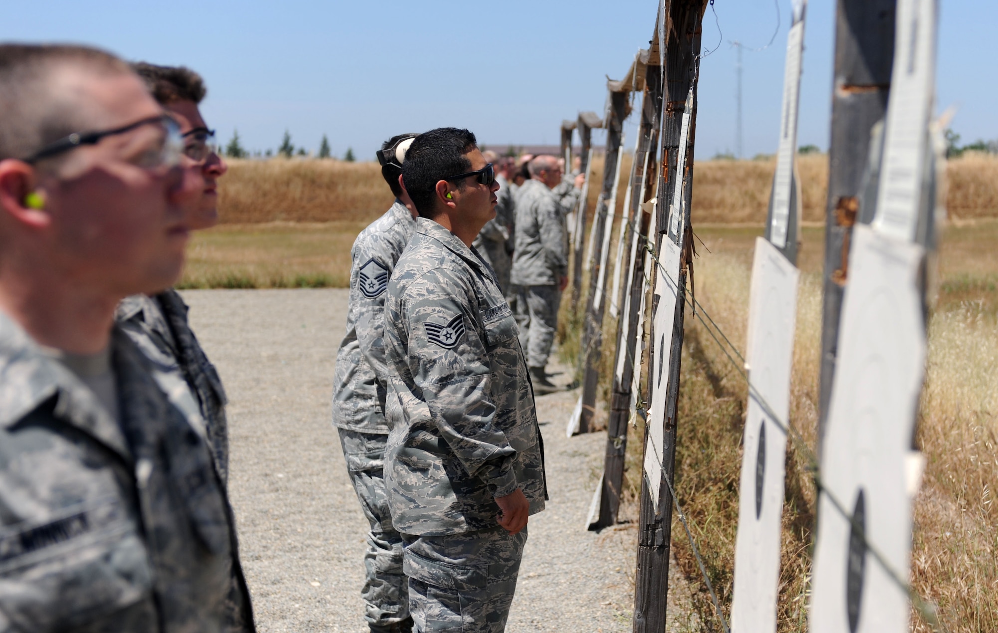 Airmen inspect their targets at the Combat Arms Training and Maintenance range on Beale Air Force Base, Calif., May 14, 2013. Seventy-five Airmen fired the M16 rifle, and the top 10 percent will receive an excellence in competition badge. (U.S. Air Force photo by Airman 1st Class Bobby Cummings/Released)
