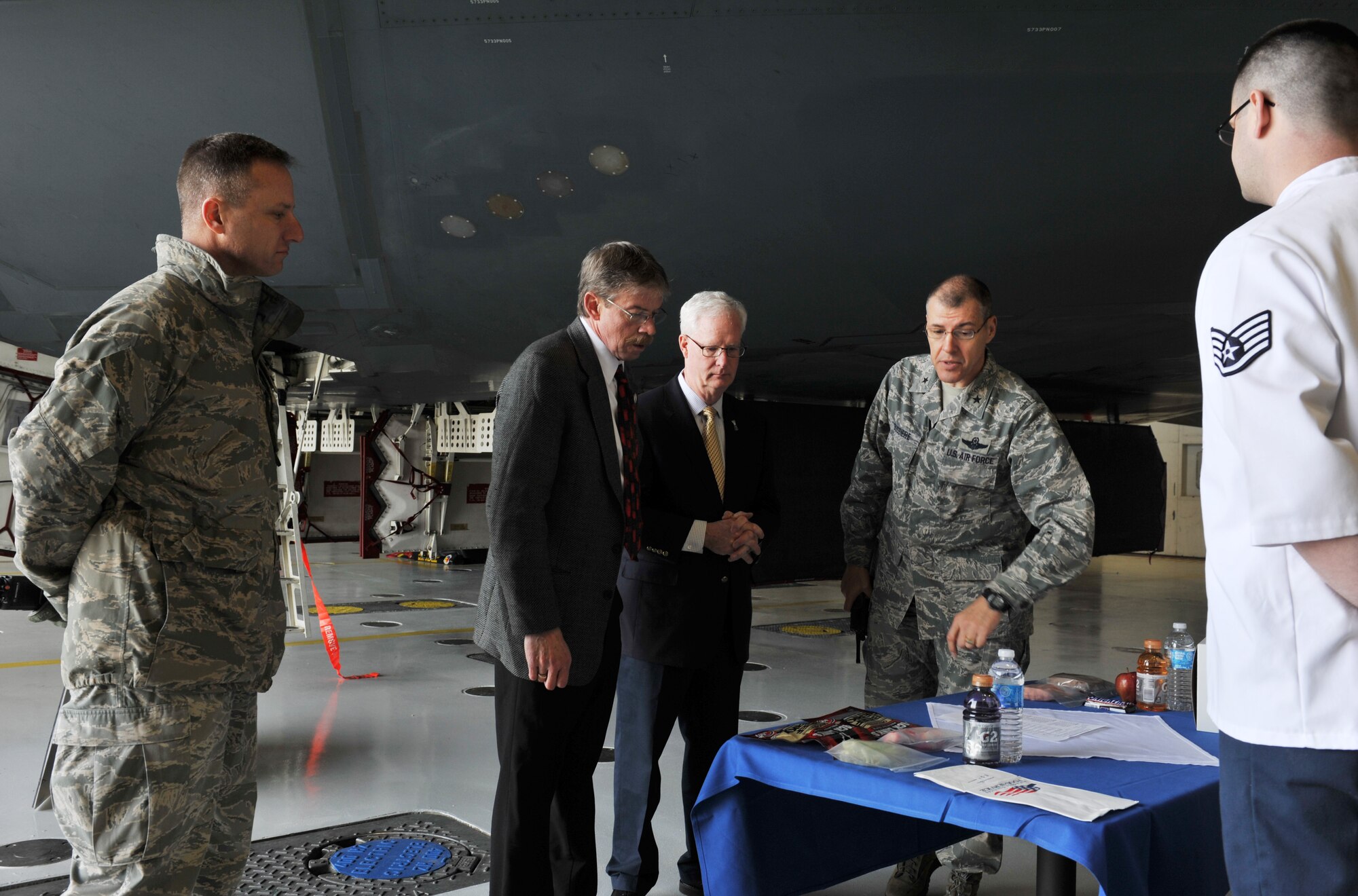 Brig. Gen. Thomas Bussiere, 509th Bomb Wing commander; Col. Christopher Darling, 509th Mission Support Group commander; and Staff Sgt. Travis Keele, 509th Force Support Squadron Touch N’ Go In-Flight Kitchen manager, describe how flight meals directly impact the B-2 Spirit mission to Air Force John L. Hennessy Trophy inspectors, April 2, 2013, at Whiteman Air Force Base, Mo. Whiteman was named winner of the 2013 Hennessy Trophy for having the best food service program in the Air Force. (U.S. Air Force photo by Heidi Hunt/Released)