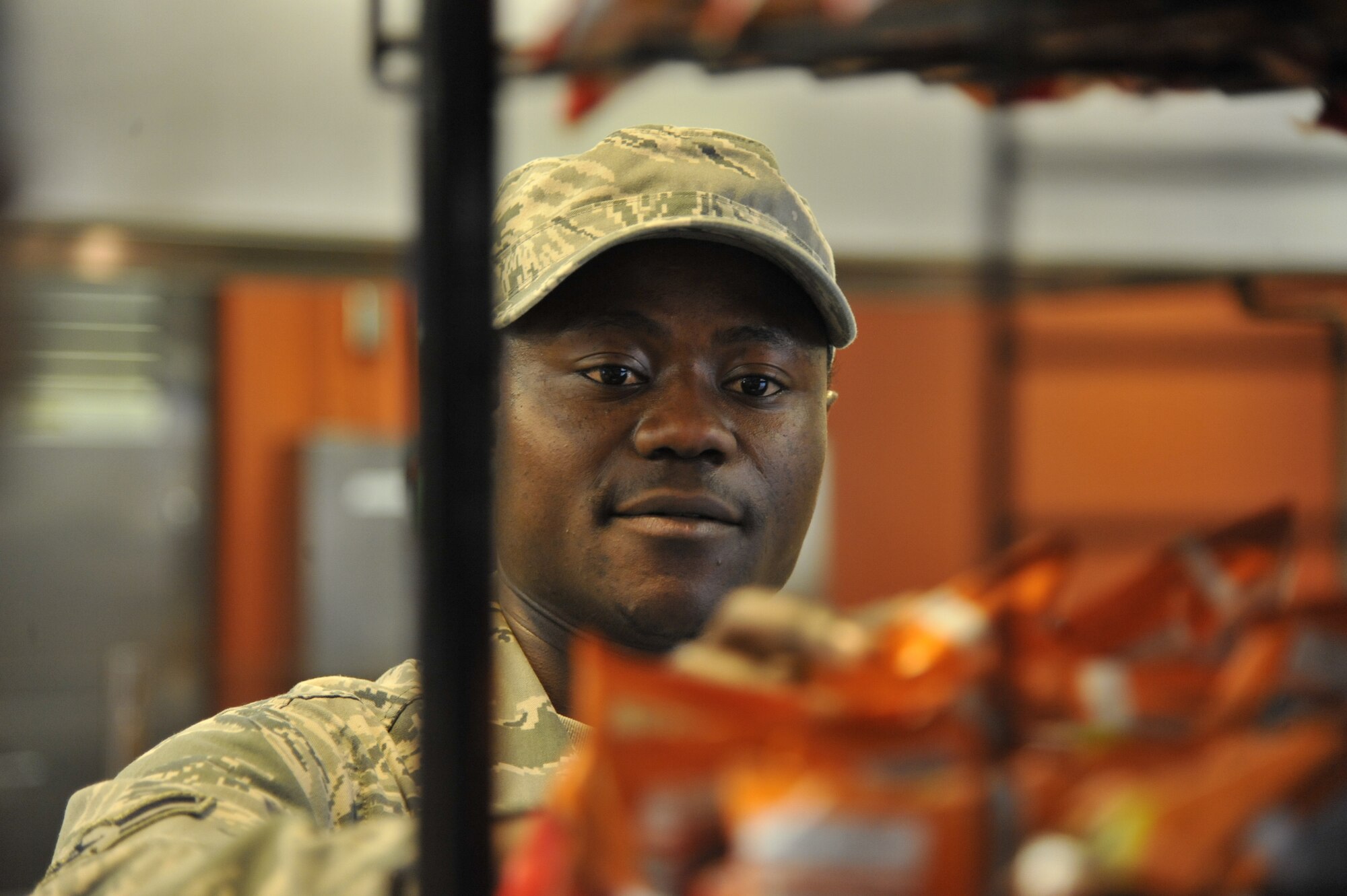 Airman 1st Class Betrand Tamunang, 509th Force Support Squadron services apprentice, restocks chips at the Ozark Inn on Whiteman Air Force Base, Mo., April 15, 2013. Menu variety and acceptability, as well as food display, are some of the grading criteria used to choose the John L. Hennessy Trophy winner. (U.S. Air Force photo by Airman 1st Class Keenan Berry/Released)