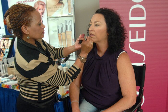 Teresa Casper receives a complimentary make-up consultation at the Military Spouse Appreciation event May 10, 2013, at Nellis Air Force Base, Nev. The Nellis Airman and Family Readiness Center hosted the annual event to show their appreciation to military spouses based here. (U.S. Air Force Photo by Caitlin Kenney/ 99th Air Base Wing Public Affairs)