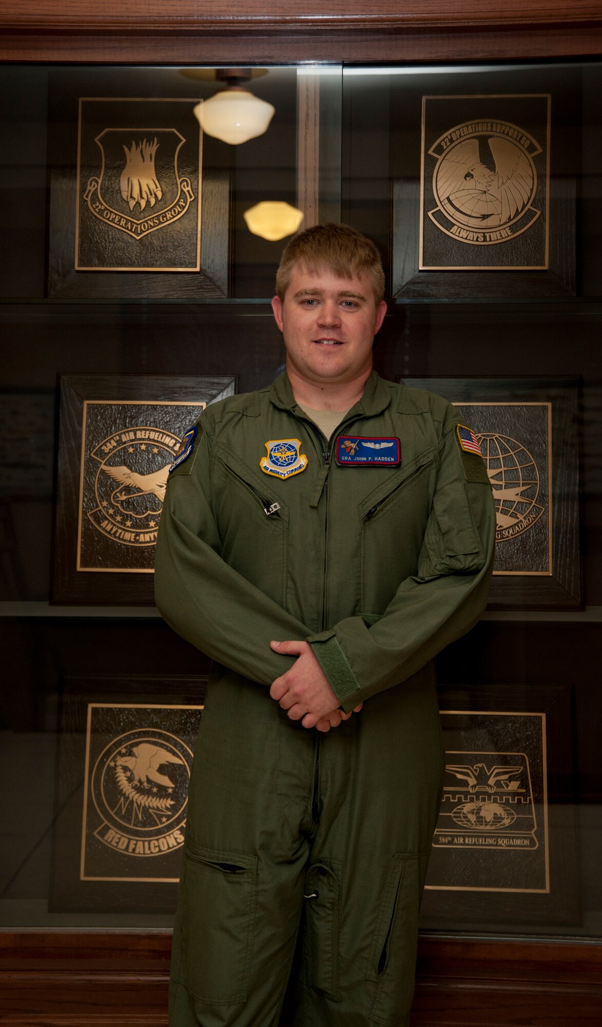 Senior Airman John Hadden, 22nd Operations Group standards and evaluations administrator, poses in front of the various trophies the 22nd OG has won  May 14, 2013, McConnell Air Force Base, Kan. Hadden was selected as the spotlight performer for the week of May 13 to 17. (U.S. Air Force photo/Airman 1st Class Victor J. Caputo)