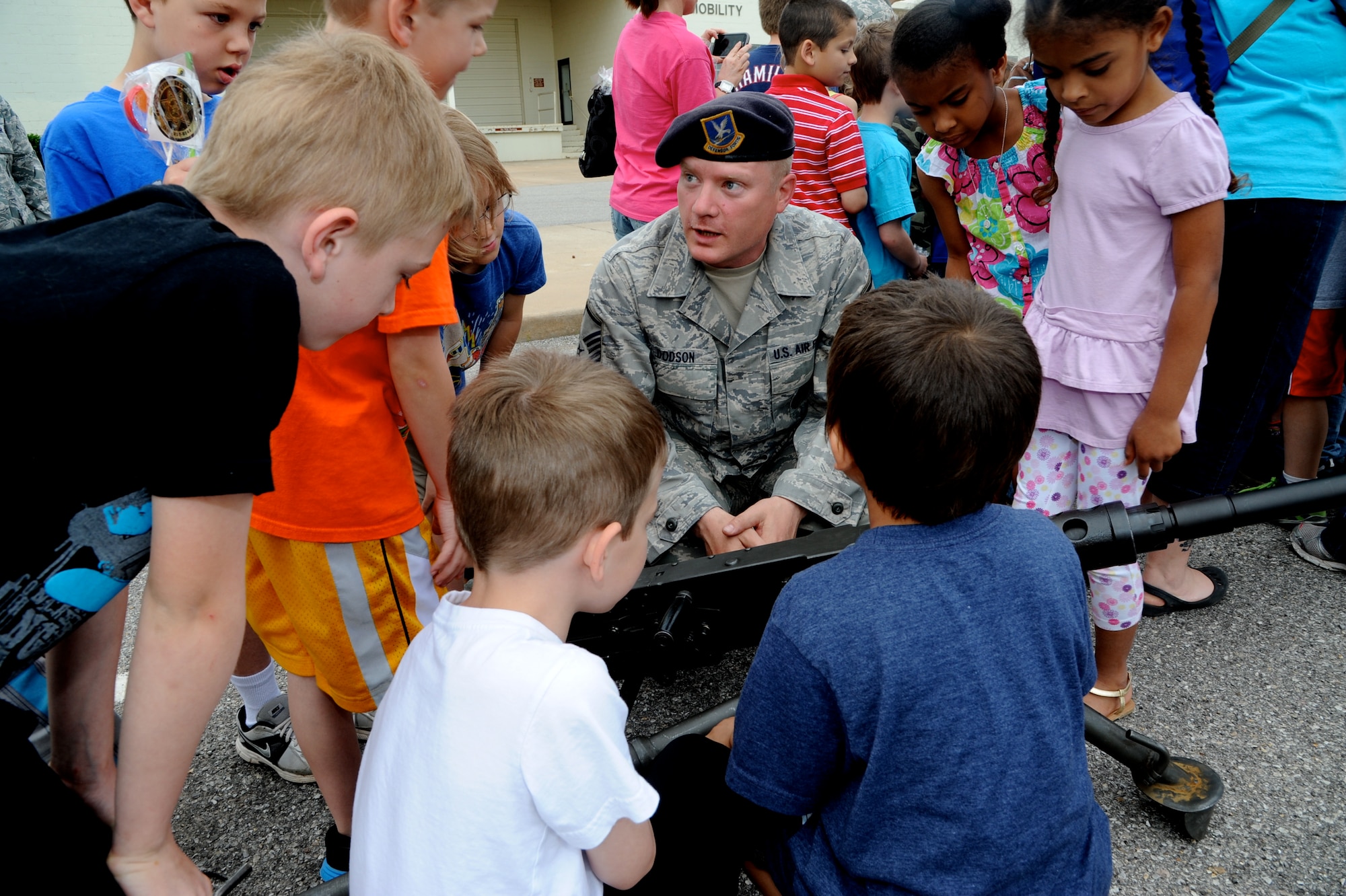 Master Sgt. Richard Dodson, the 71st Security Forces Squadron operations superintendent, explains the ins and outs of the M2 machine gun to school children, May 15, during National Police Week at Vance Air Force Base, Okla. (U.S. Air Force photo/ Senior Airman Frank Casciotta)