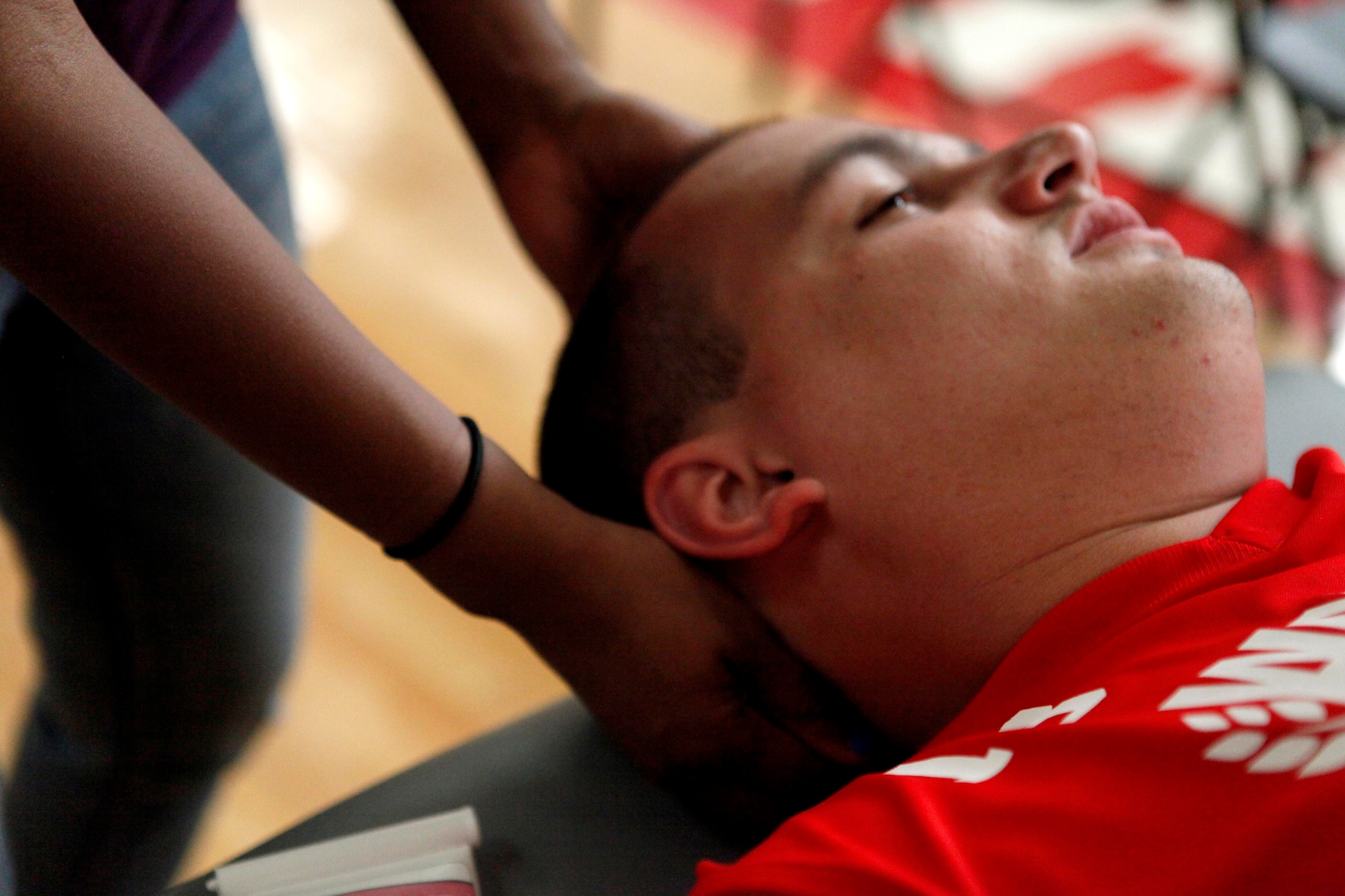Zach Blair, Marine Corps team member, gets a massage May 12, 2013, before a wheelchair basketball game at the 2013 Warrior Games in Colorado Springs, Colo. Jeanette Falu-Bishop, the founder and executive director of Structure for Wounded Warriors, has offered body work to all competitors at the games. (U.S. Marine Corps photo/Sgt. Justin Boling) 