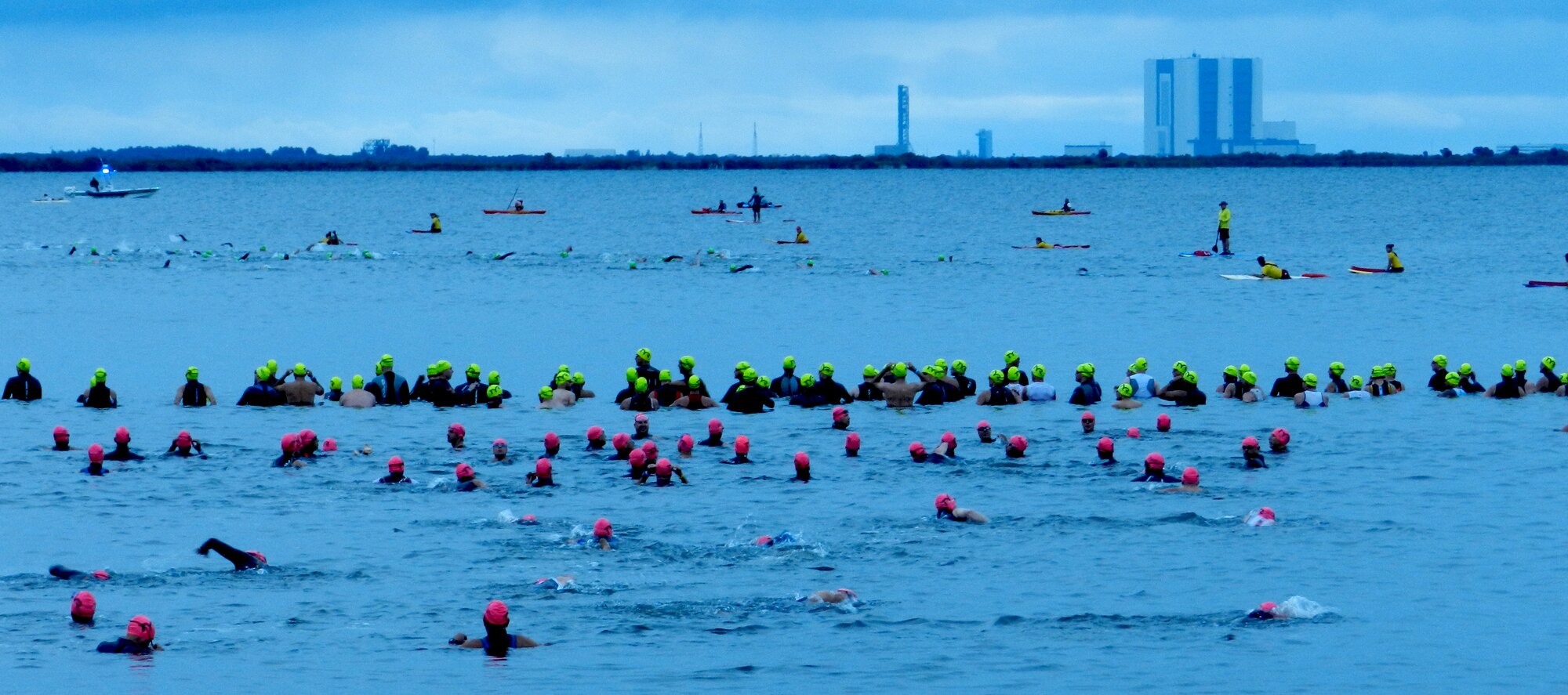 After the opening ceremony of the Space Coast Rocketman Triathlon May 5, 1,600 athletes from around the globe dove into the brackish Indian River in Titusville, Fla., to start the swimming portion of the event. Senior Airman Caitlin Novell, 920th Rescue Wing, Patrick Air Force Base, Fla., sang the national anthem at the opening, and participants also paid tribute to the Boston Marathon victims who were killed or injured April 15. (U.S. Air Force photo/Maj. Don Kerr)