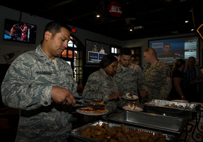 First Lieutenant Rogelio Rodriguez, 437th Aerospace Medicine Squadron deputy flight commander, serves himself at the buffet line during the Rookies Sports Grill one-year anniversary celebration May 8, 2013, at Joint Base Charleston – Air Base, S.C. The event included a live band, hot dog eating contest and buffet for service members, retirees and their families to try out to try out new menu options. (U.S. Air Force photo/ Senior Airman Dennis Sloan)