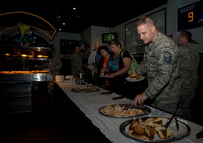 Master Sgt. Jim Davenport, 437th Medical Support Squadron superintendent, helps himself to the buffet line during the Rookies Sports Grill one-year anniversary celebration May 8, 2013, at Joint Base Charleston – Air Base, S.C. The event included a live band, hot dog eating contest and buffet for service members, retirees and their families to try out new menu options. (U.S. Air Force photo/ Senior Airman Dennis Sloan)
