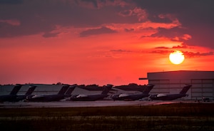 C-17 Globemaster III’s sit on the flightline as the sun sets May 9, 2013, at Joint Base Charleston – Air Base, S.C. The C-17 is capable of rapid strategic delivery of troops and all types of cargo to main operating bases or directly to forward bases in the deployment area. The aircraft can perform tactical airlift and airdrop missions and can transport litters and ambulatory patients during aeromedical evacuations when required. (U.S. Air Force photo/ Senior Airman Dennis Sloan)