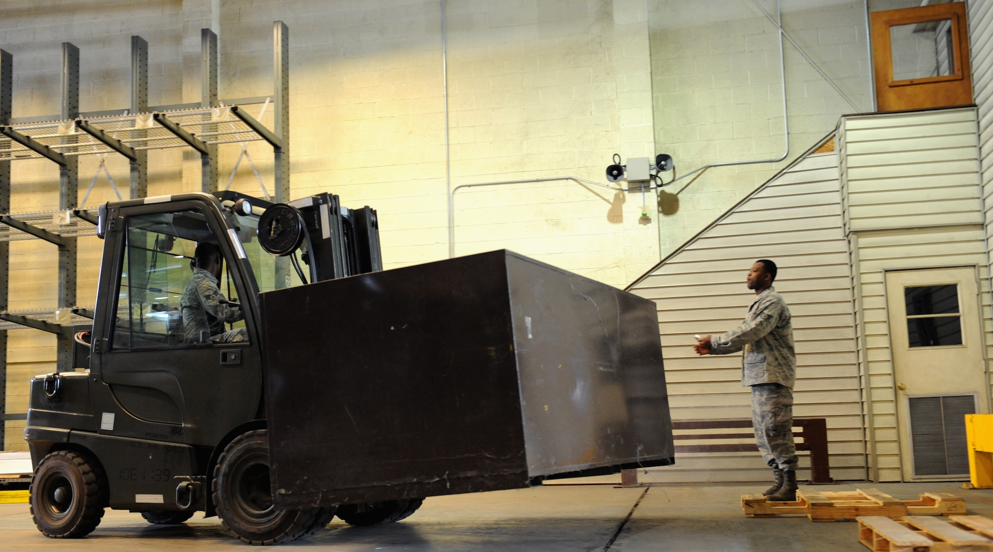 Senior Airman Marcus Robins, 2nd Logistics Readiness Squadron storage and issue, lifts a storage bin while operating a forklift on Barksdale Air Force Base, La., May 15, 2013. Airmen from the 2nd LRS storage and issue section uses a variety of equipment including forklifts, hysters and ladders to access the parts base personnel need. (U.S. Air Force photo/Airman 1st Class Benjamin Gonsier)