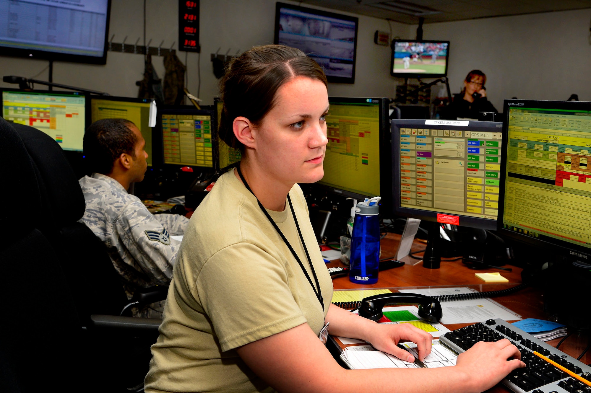 Airman Maura Tunney, 436 Airlift Wing command post emergency action controller, coordinates cargo with the Air Terminal Operations Center May 15, 2013, at the command post on Dover AFB, Del., to ensure an on time departure. Personnel from the command post, ATOC and Maintenance Operations Control Center work together to keep aircraft and cargo moving. (U.S. Air Force photo/David S. Tucker)