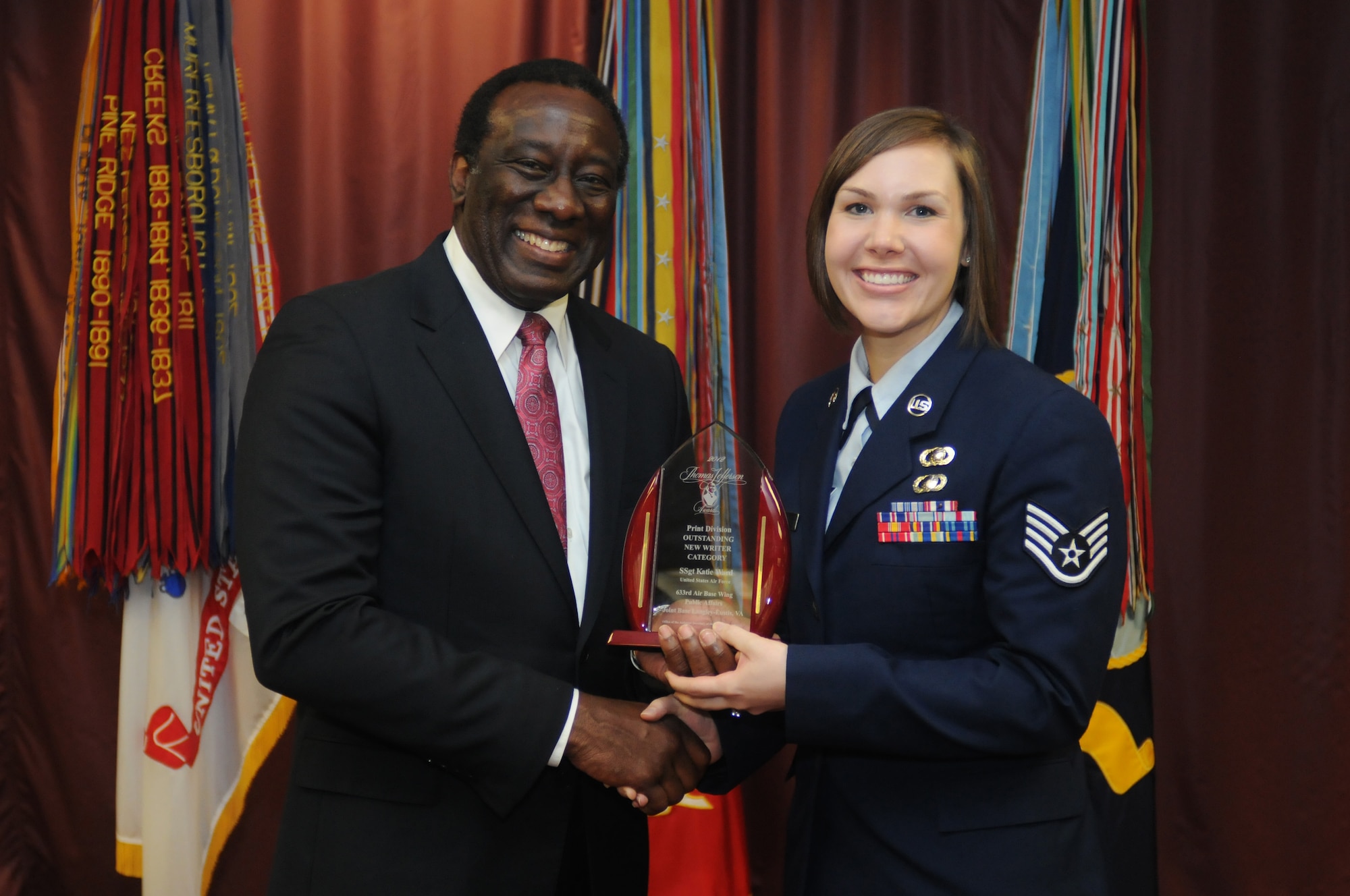 U.S. Air Force Staff Sgt. Katie Ward, 633rd Air Base Wing Public Affairs photojournalist, accepts the Thomas Jefferson Award for Outstanding New Writer of the Year from Ray B. Shepherd, Defense Media Activity Director, during the 2013 Communicators of Excellence awards ceremony at the Defense Information School at Fort George G. Meade, Md., May 10, 2013. The award ceremony recognizes the efforts of military and Department of Defense civilian journalists and visual communicators who earned honors in the Thomas Jefferson Awards Program and the Visual Information Awards Program. Ward serves as the managing editor of the Joint Base Langley-Eustis base newspaper, The Peninsula Warrior. (U.S. Navy photo by Mass Communication Specialist 2nd Class Justin Stumberg/Released) 