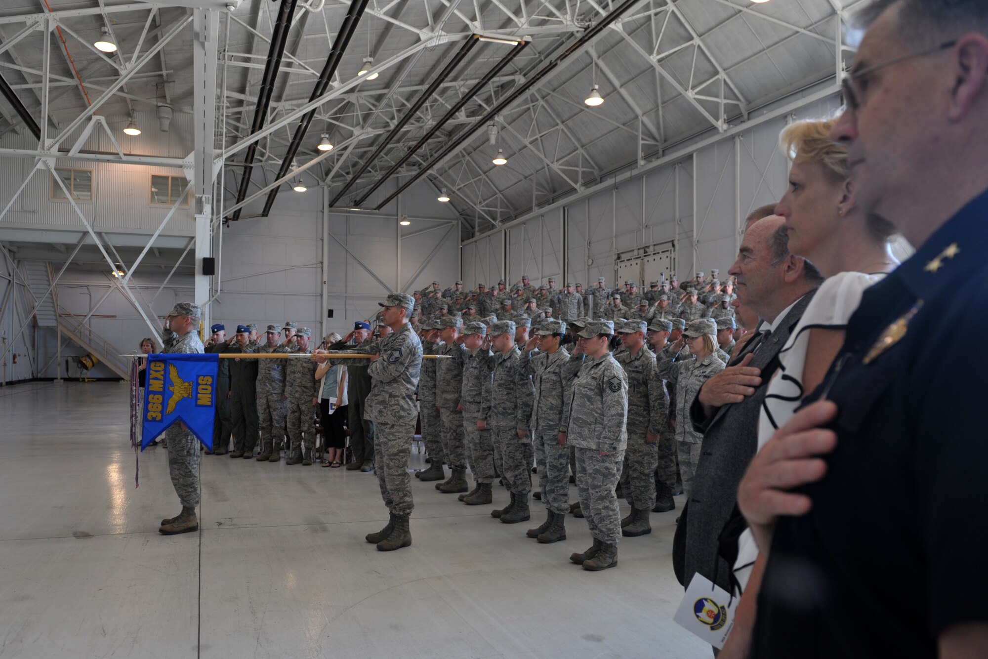 U.S. Air Force members and civic leaders show respect to the flag as the National Anthem is sang during the 366th Maintenance Operations Squadron’s inactivation ceremony, May 13, 2013, at Mountain Home Air Force Base, Idaho. MOSs Air Force-wide are scheduled to be inactivated by the end of the fiscal year in an effort to better align field and company grade officer positions with operational requirements. (U.S. Air Force photo by Senior Airman Heather Hayward/Released)
