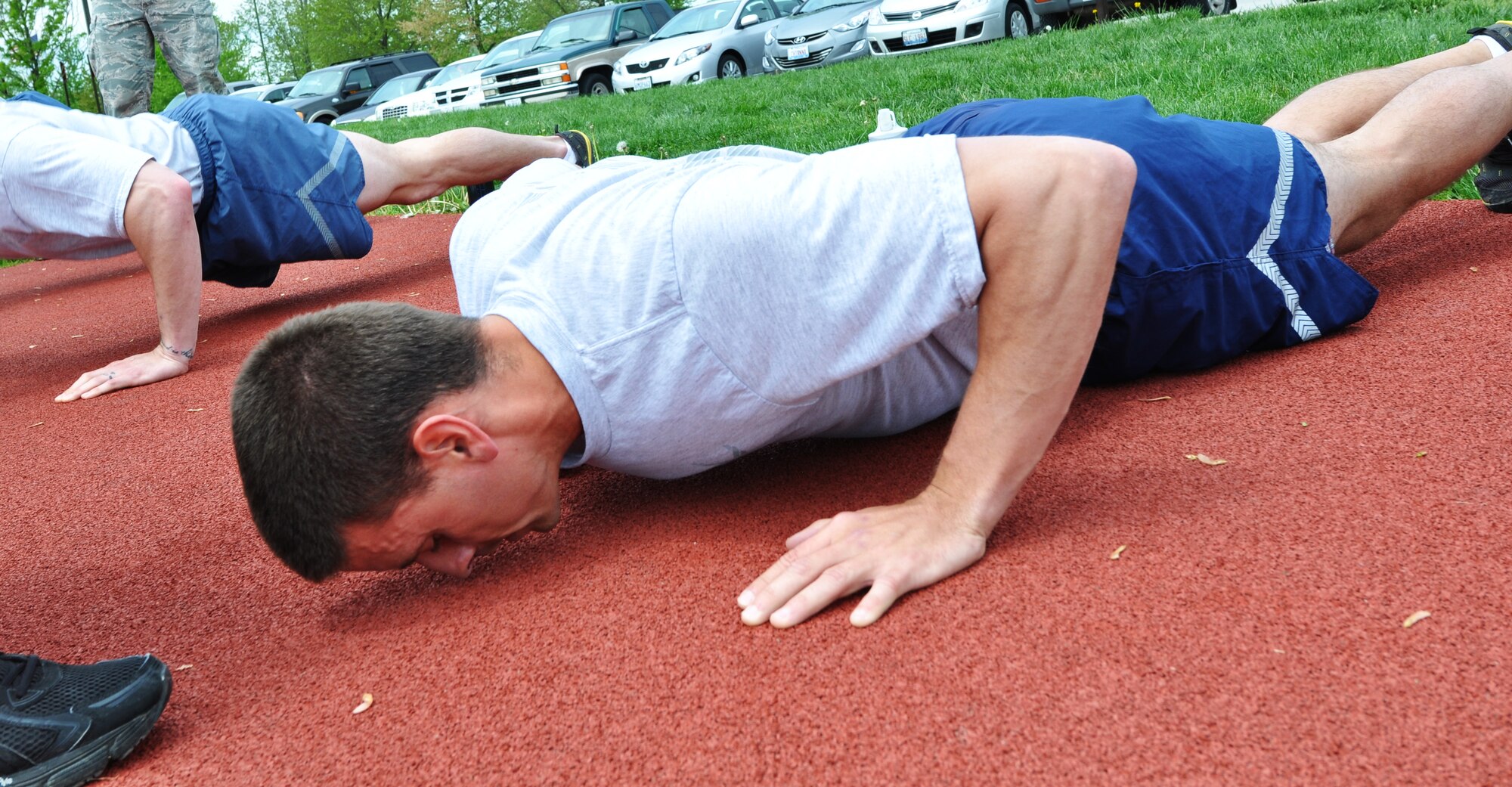 An airmen does pushups at James Gym track May 6, 2013. The PAST requires that pushups must be completed in perfect form. (U.S. Air Force Photo by Airman Megan Friedl)