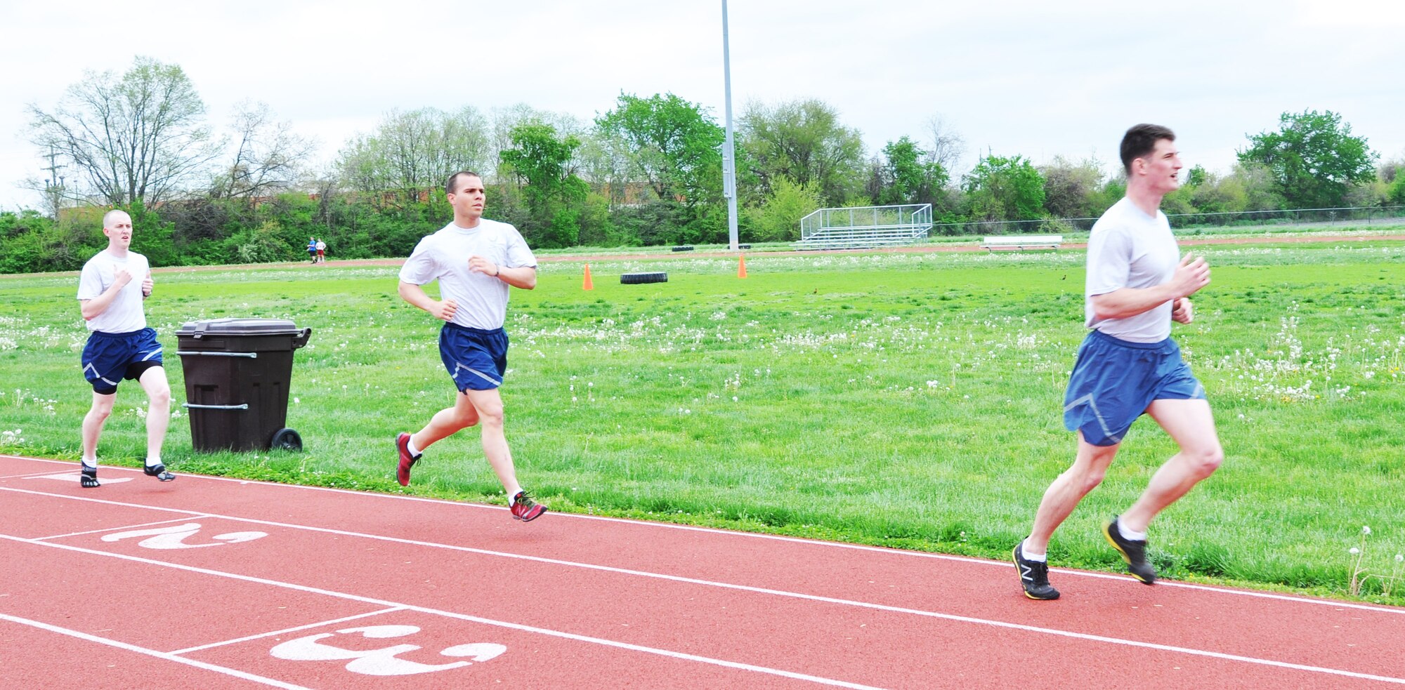 Airmen sprint the last few laps they have at the James Gym track May 6, 2013. Airmen had to complete a 1.5 mile run as a part of the PAST. (U.S. Air Force Photo by Airman Megan Friedl)