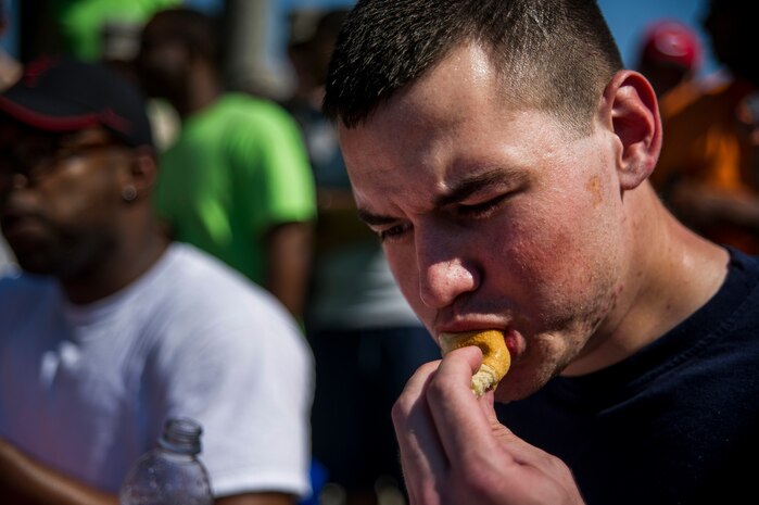 Staff Sgt. William O'Brien, 628th Air Base Wing photojournalist, eats another hot dog during the Dorm Tailgate Party Hot Dog Eating contest May 10, 2013, at Joint Base Charleston – Air Base, S.C. The Tailgate Party was designed to strengthen social ties among dorm members and enhance their esprit de corps. The party was sponsored by the Single Airman's Initiative Program and the Air Force Sergeants Association, and included a dirty truck competition, a hot dog eating contest, a basketball tournament and a live DJ. (U.S. Air Force photo/ Senior Airman George Goslin)